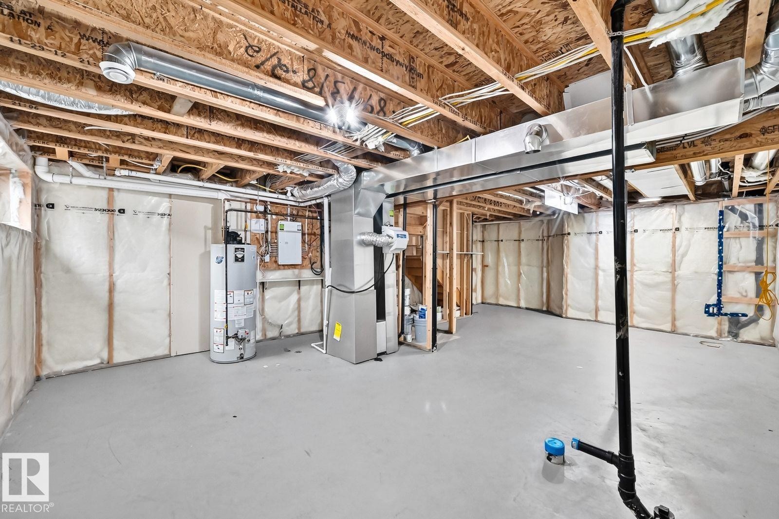 Unfinished lower level featuring exposed wood joists, gray concrete flooring, and insulated perimeter walls - 1112 176 Street Sw, Edmonton, AB - Indoor Photo Showing Basement