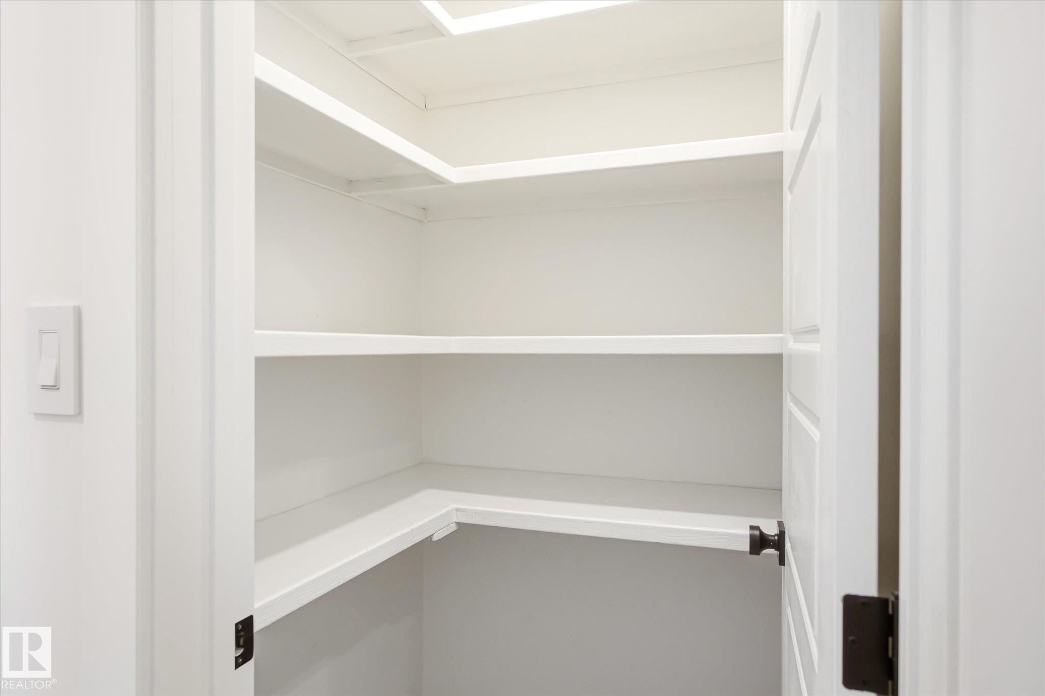 White built-in shelving providing ample storage - 4708 104A Avenue Nw, Edmonton, AB - Indoor With Storage