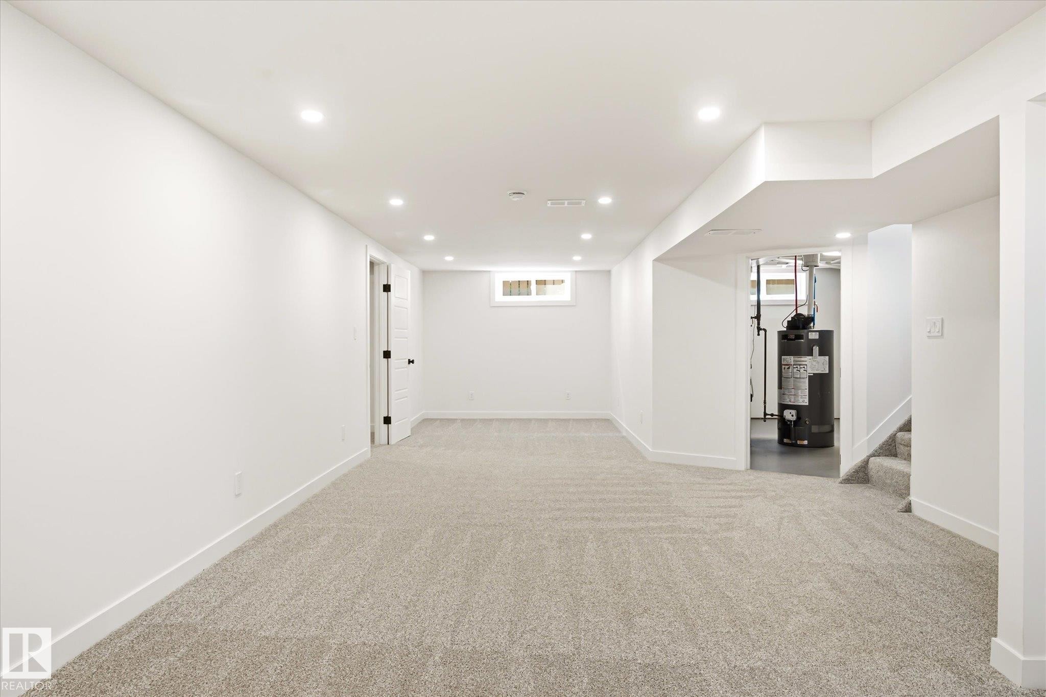 Finished lower level featuring recessed lighting, light-toned carpet, white walls, and a small window - 4708 104A Avenue Nw, Edmonton, AB - Indoor Photo Showing Other Room