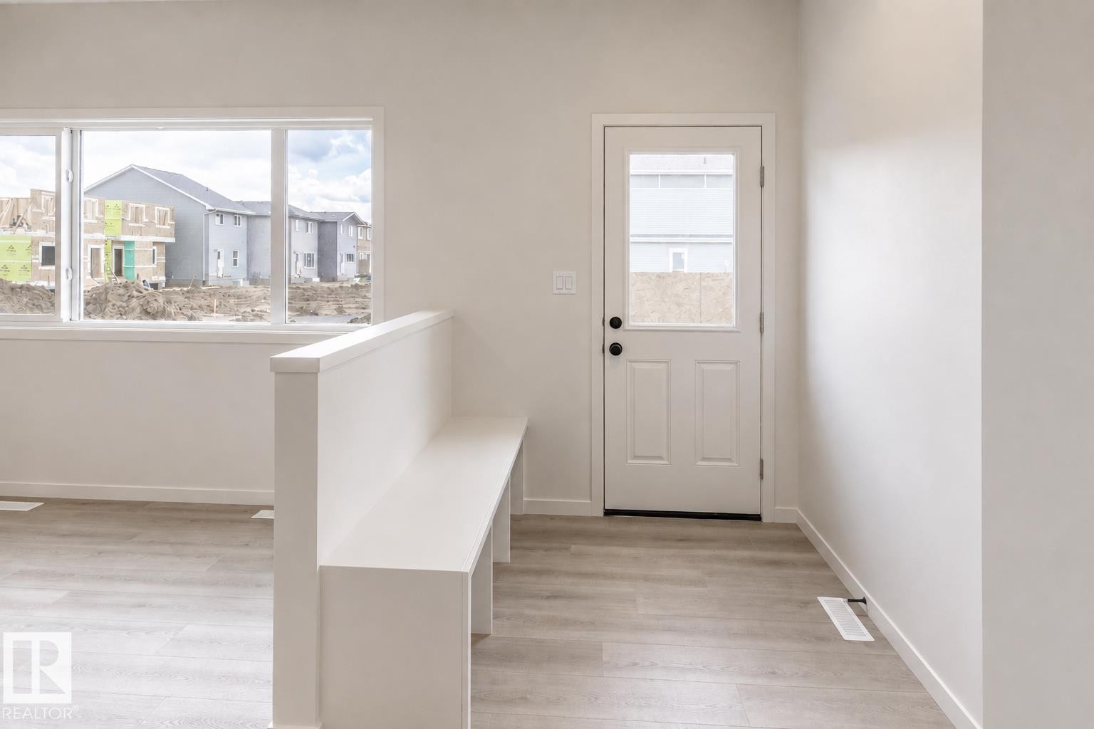 Bright interior with wood-finish flooring - 219 157 Avenue Ne, Edmonton, AB - Indoor Photo Showing Other Room