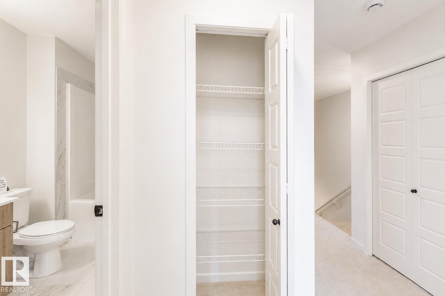 Wire shelving pantry storage - 219 157 Avenue Ne, Edmonton, AB - Indoor Photo Showing Bathroom