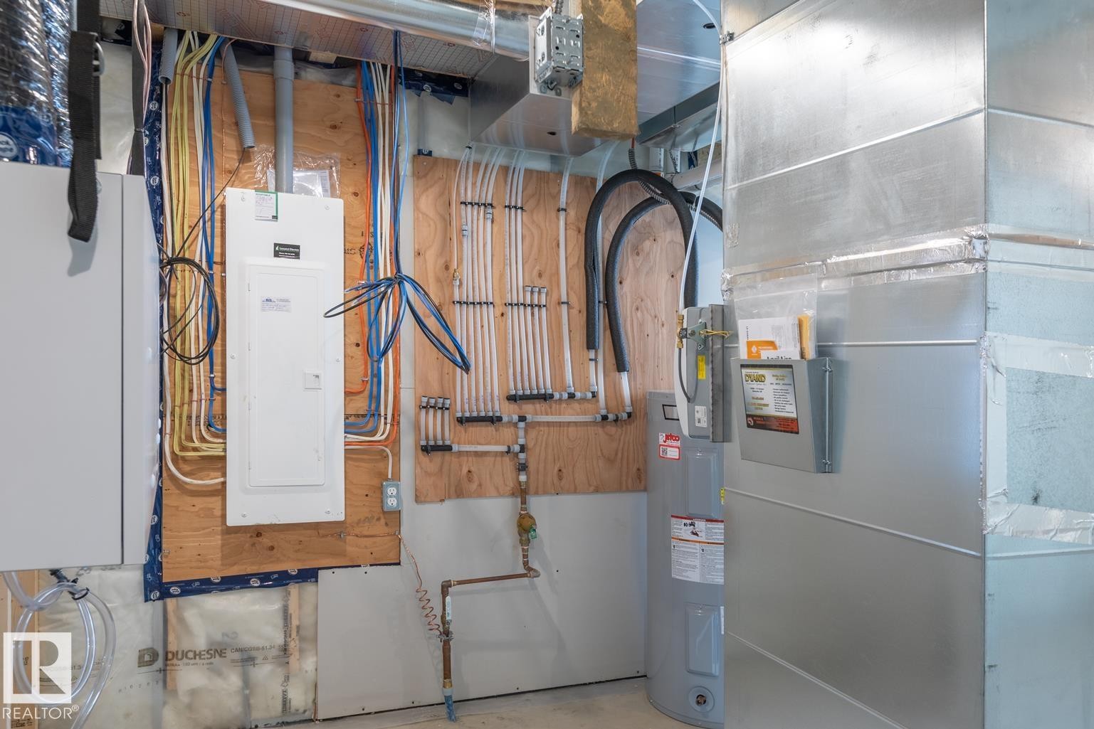 Electrical panel and hot water heater - 219 157 Avenue Ne, Edmonton, AB - Indoor Photo Showing Basement
