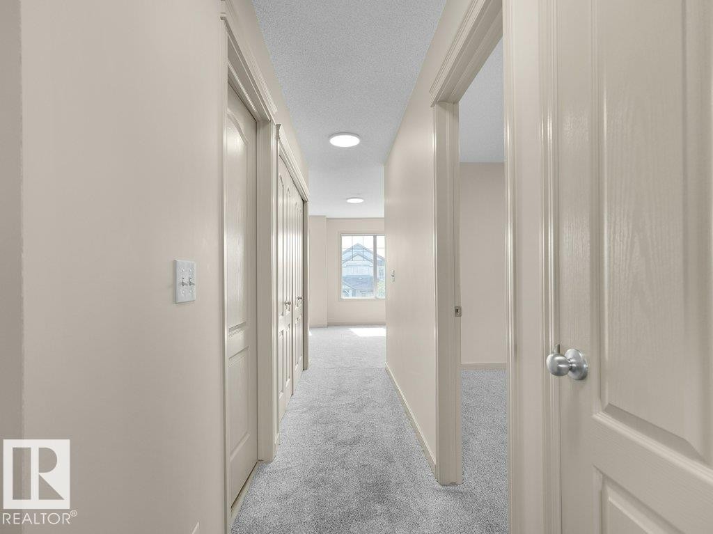 Hallway with recessed lighting, light-toned walls, and grey carpet flooring - 3010 17A Ave Nw, Edmonton, AB - Indoor Photo Showing Other Room