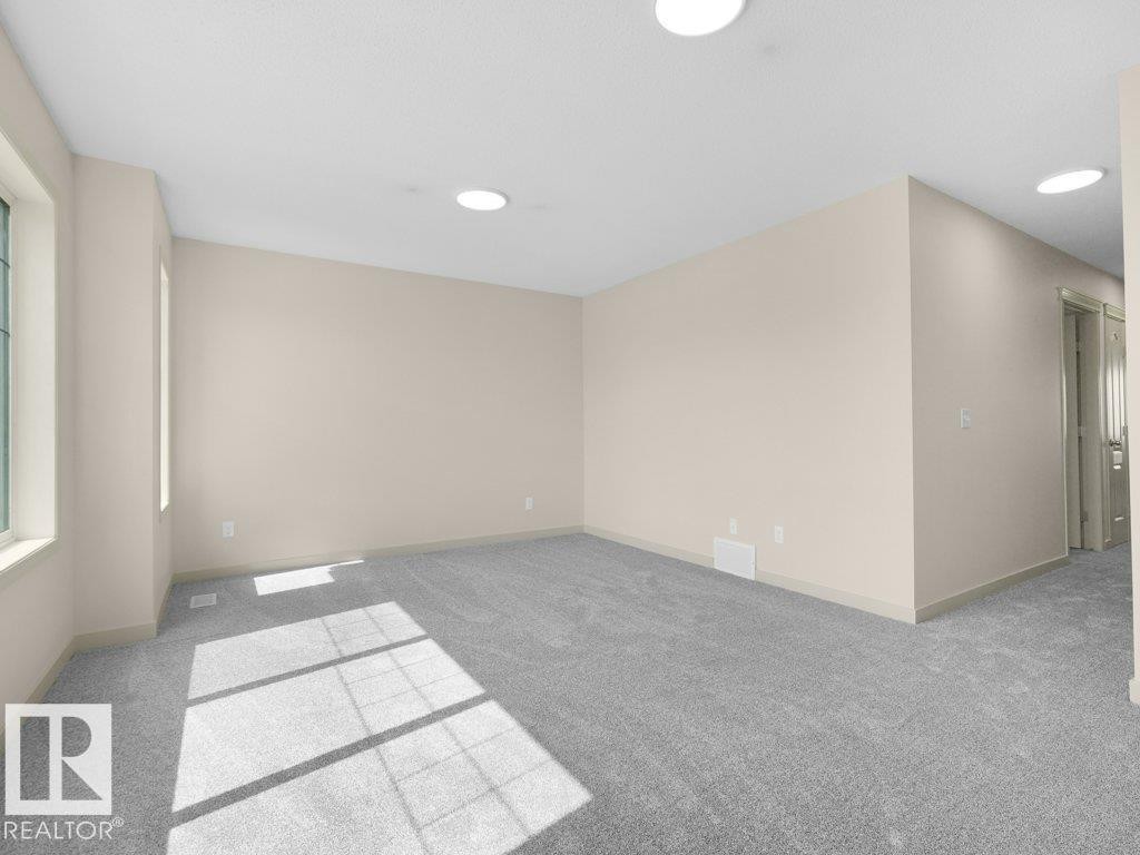 Light beige wall paint, plush gray carpeting, recessed ceiling lighting, and white window trim - 3010 17A Ave Nw, Edmonton, AB - Indoor Photo Showing Other Room