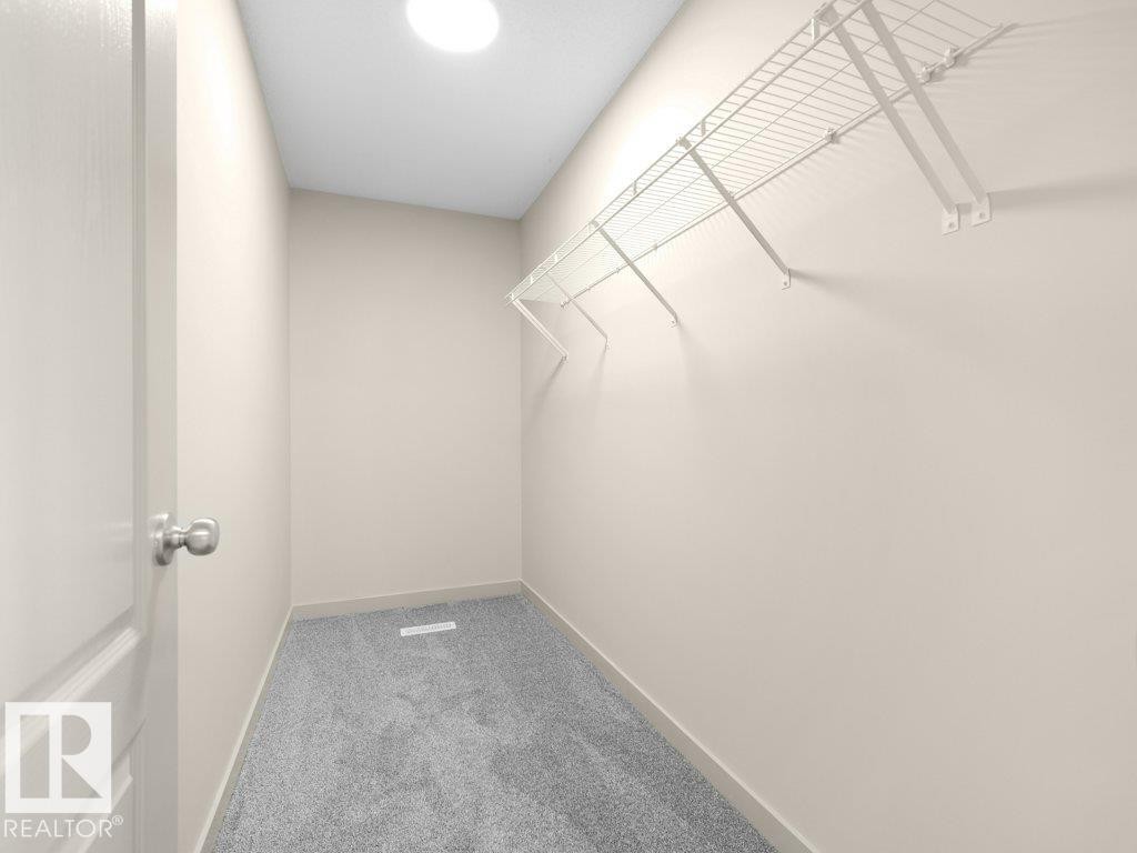 Walk-in closet featuring wire shelving, gray carpeting, and a flush-mount ceiling light - 3010 17A Ave Nw, Edmonton, AB - Indoor With Storage