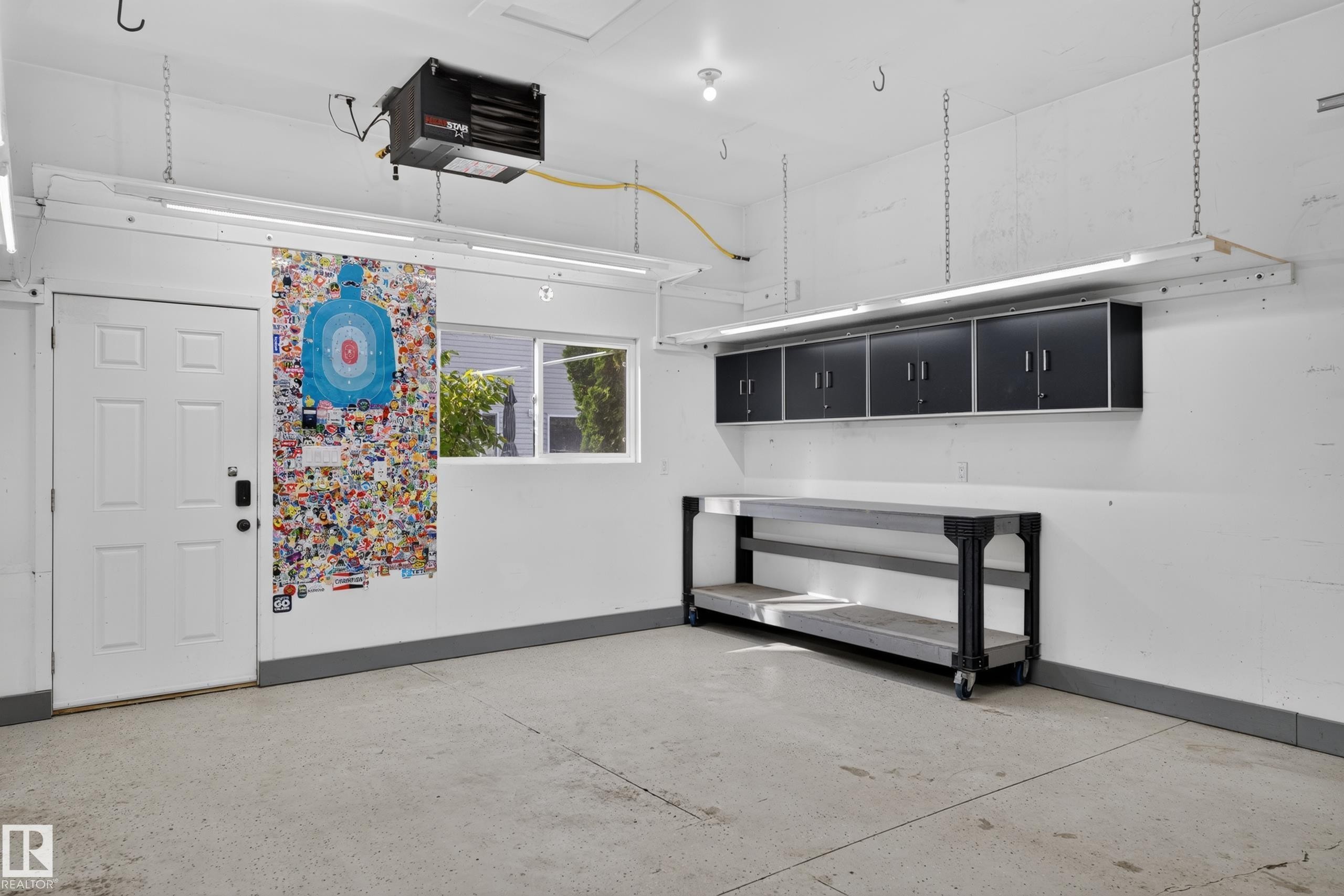 Concrete flooring, built-in wall cabinets, and an overhead heater - 6008 South Terwillegar Boulevard Nw, Edmonton, AB - Indoor Photo Showing Other Room