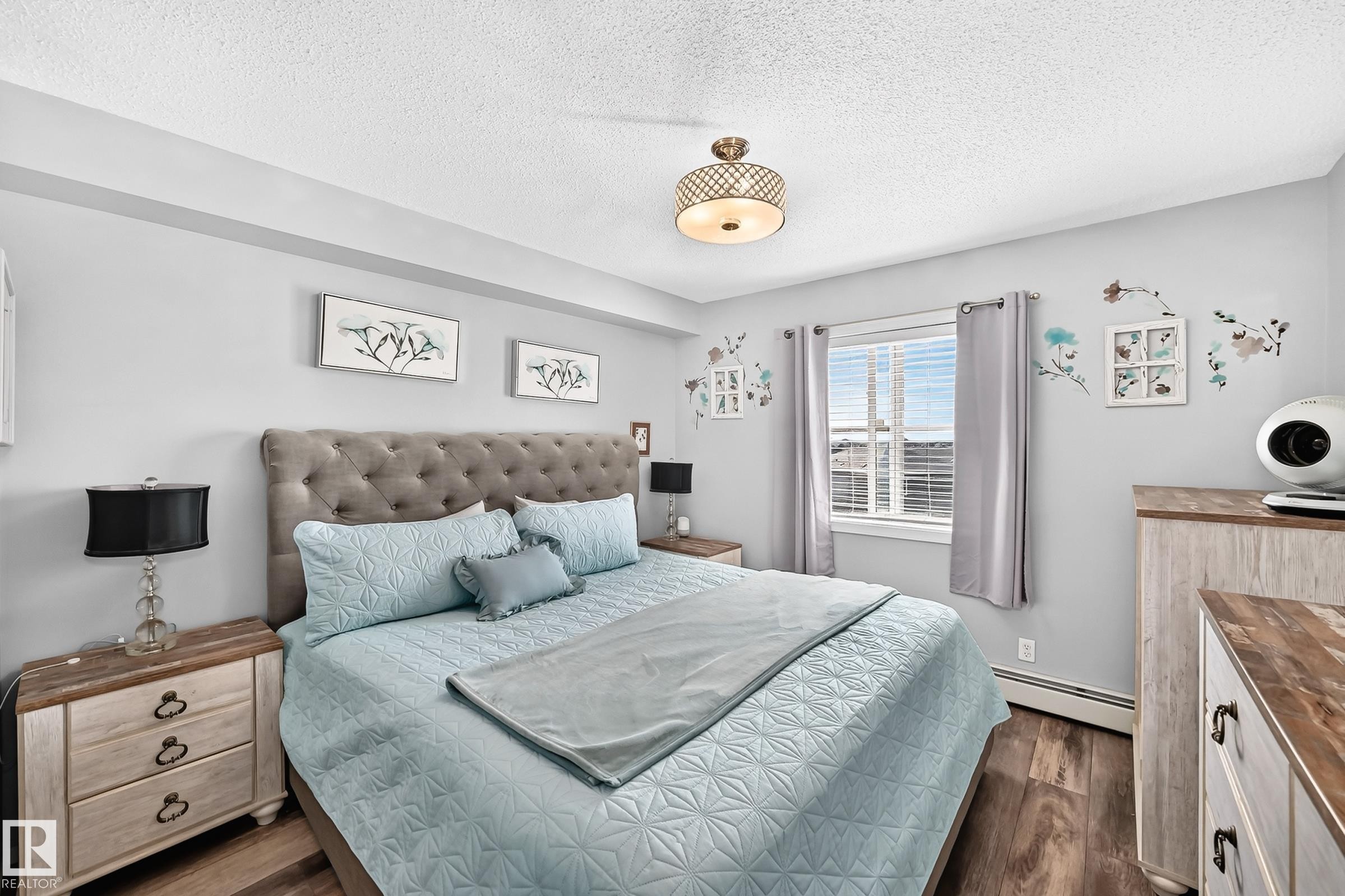 Wood-finish flooring with light-toned walls - #401 5390 Chappelle Rd Sw, Edmonton, AB