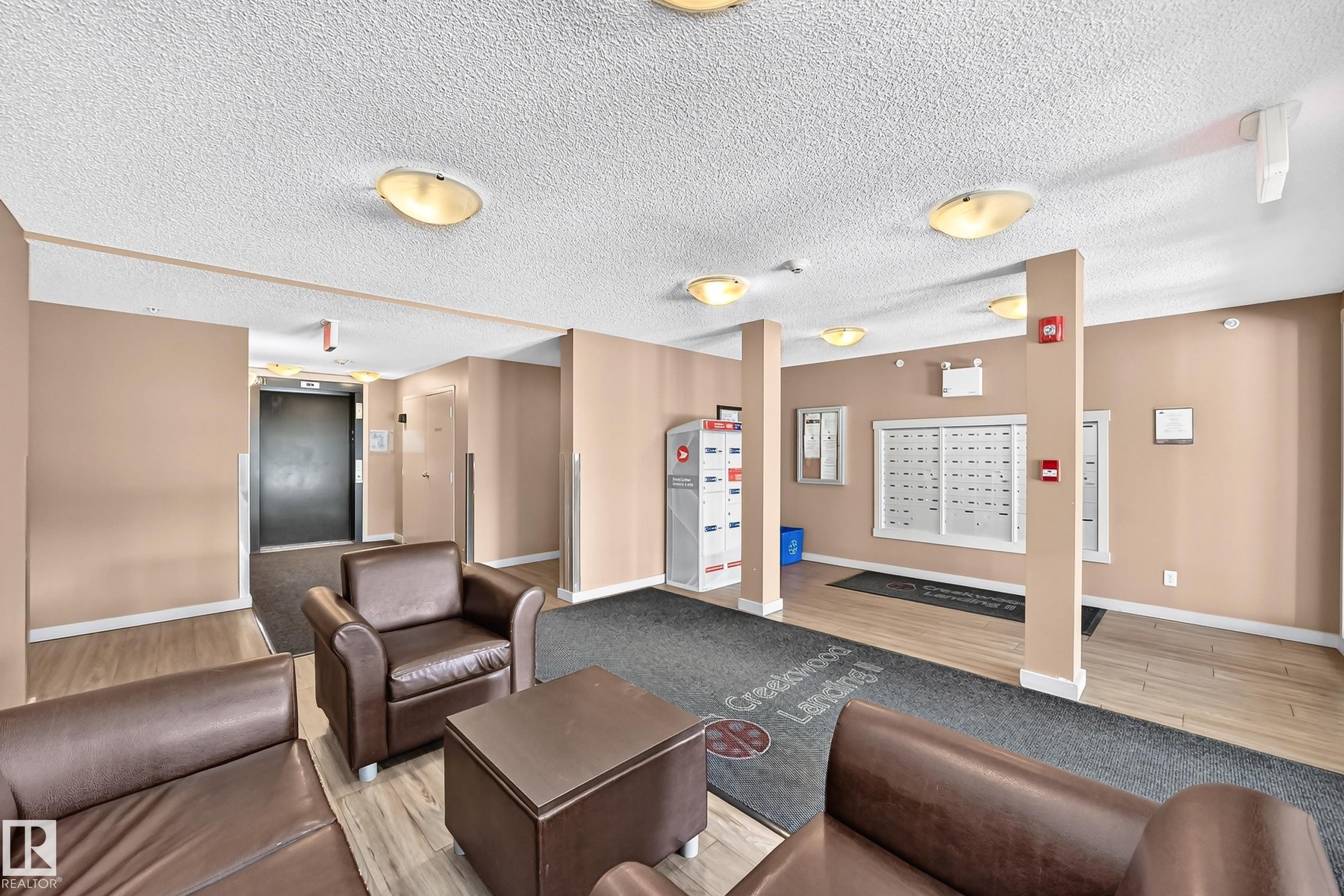 Common area featuring mailboxes, parcel lockers, and flush-mount ceiling lighting - #401 5390 Chappelle Rd Sw, Edmonton, AB