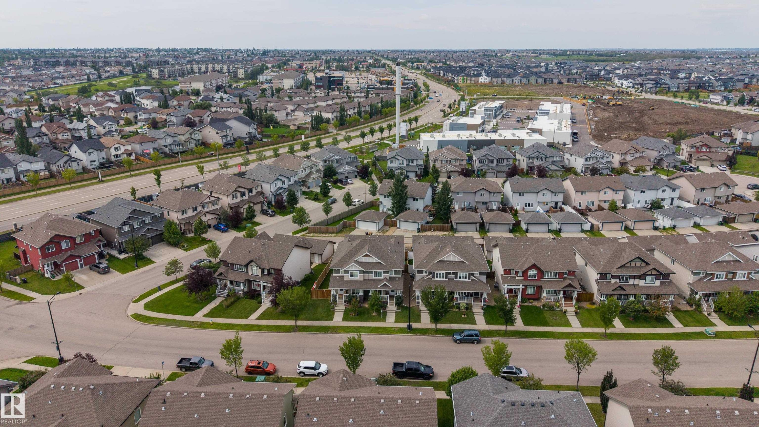Expansive suburban residential neighborhood featuring a variety of single-family homes and a commercial development - 124 Cy Becker Boulevard Nw, Edmonton, AB - Outdoor With View