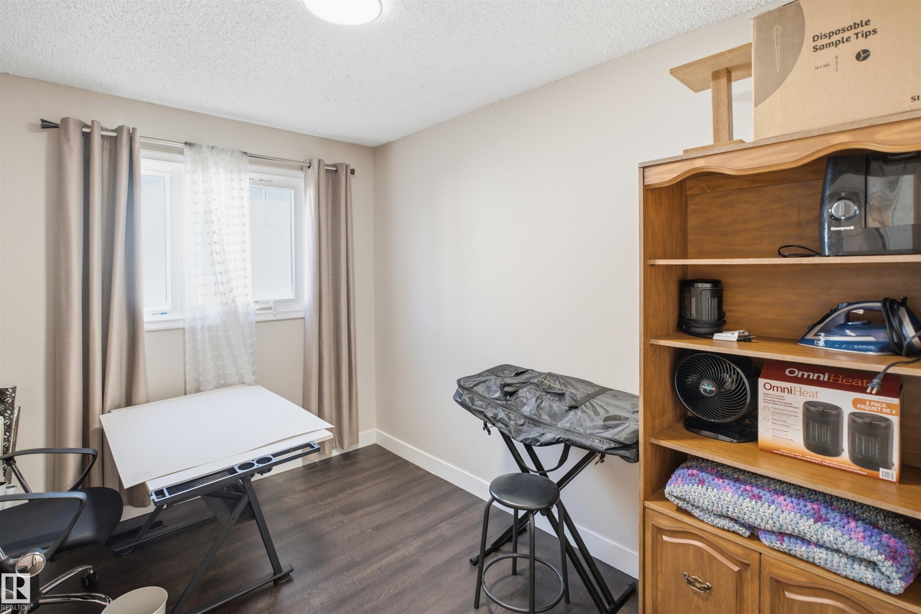 Wood-finish flooring, light-toned walls, and a window with natural light - 3515 20 Ave Nw, Edmonton, AB