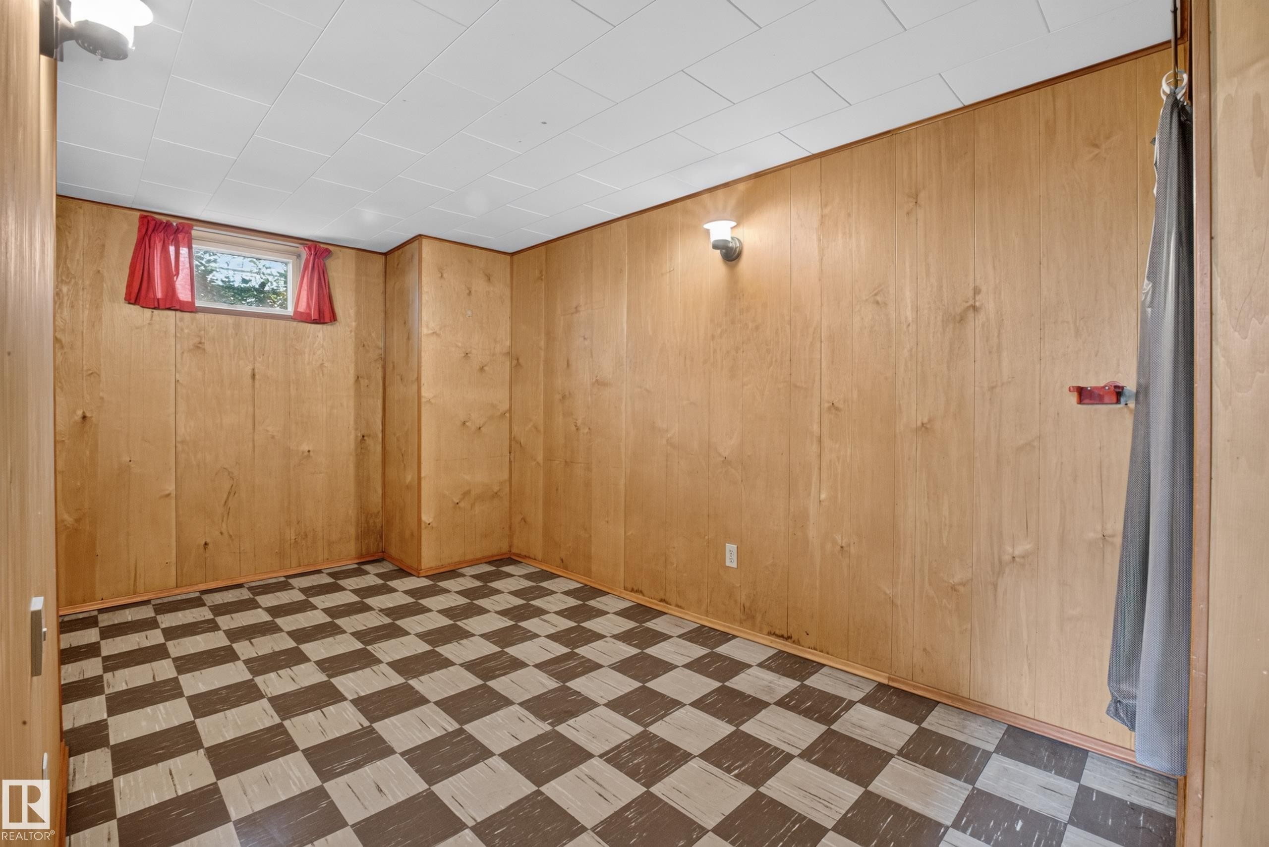 Paneling-clad walls, checkered flooring, and a drop ceiling - 16009 93A Avenue Nw, Edmonton, AB - Indoor
