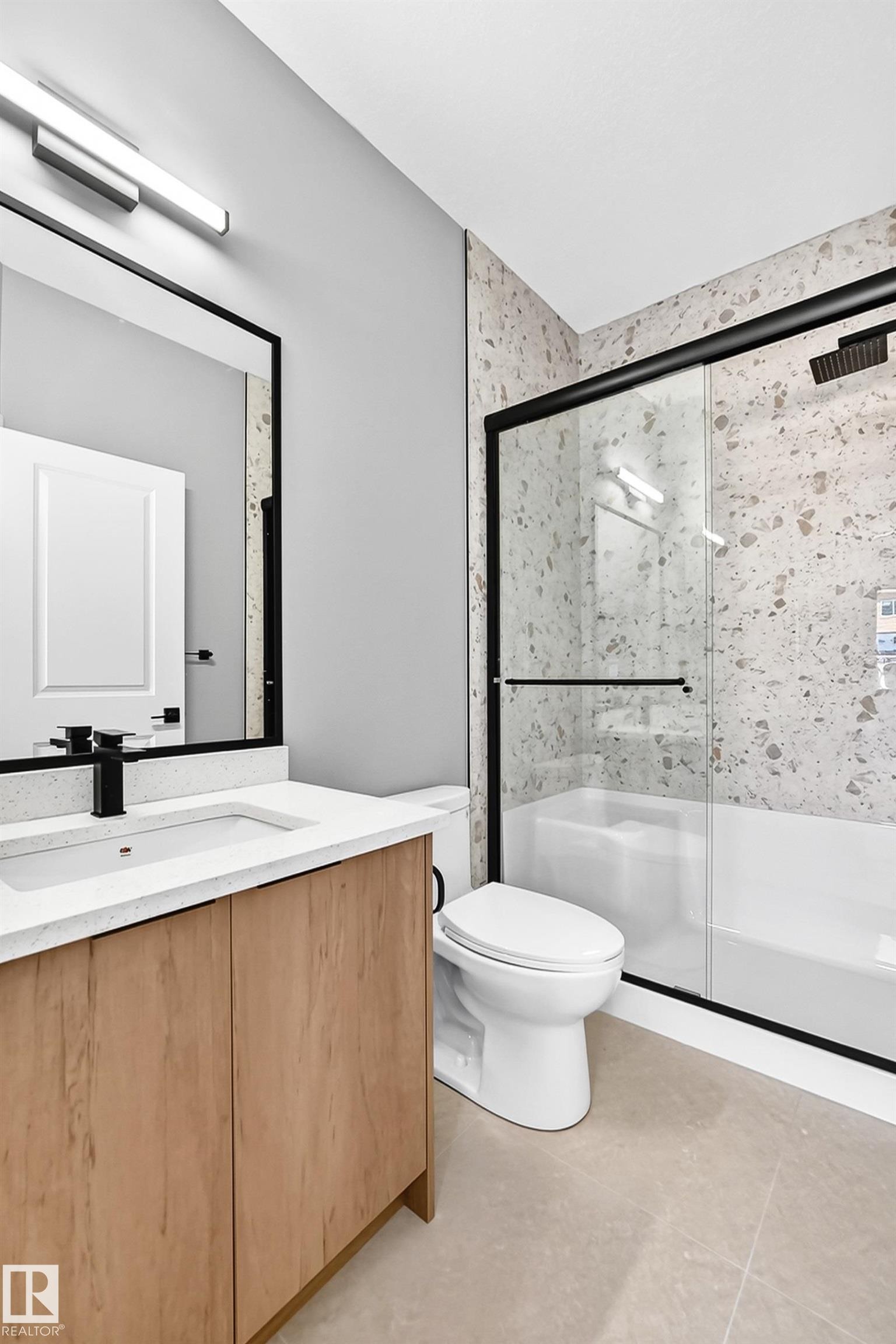 Light wood-finish vanity with a white countertop and rectangular sink - 426 Crystal Creek Link, Leduc, AB - Indoor Photo Showing Bathroom
