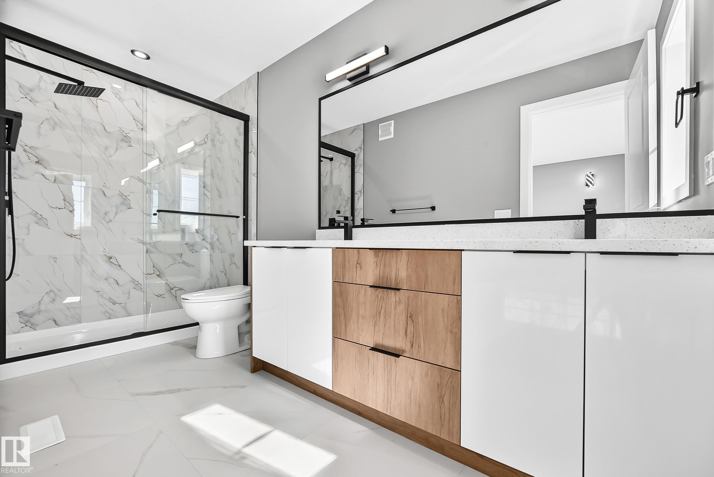 Double vanity with white and wood-finish cabinetry, white countertops, and matte black fixtures - 426 Crystal Creek Link, Leduc, AB - Indoor