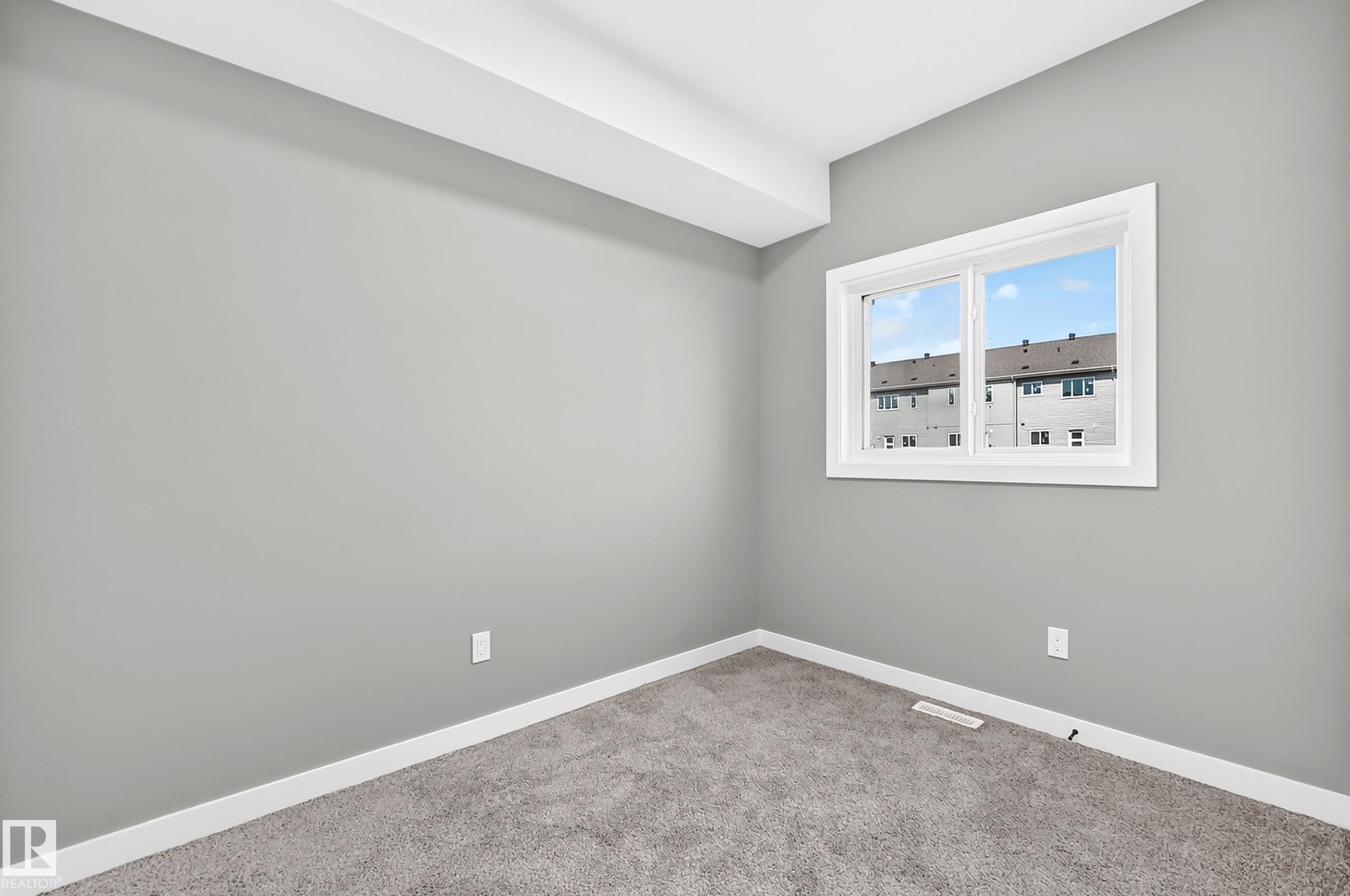 Carpeted flooring, gray wall paint, white trim, and a double-pane window - 426 Crystal Creek Link, Leduc, AB - Indoor Photo Showing Other Room