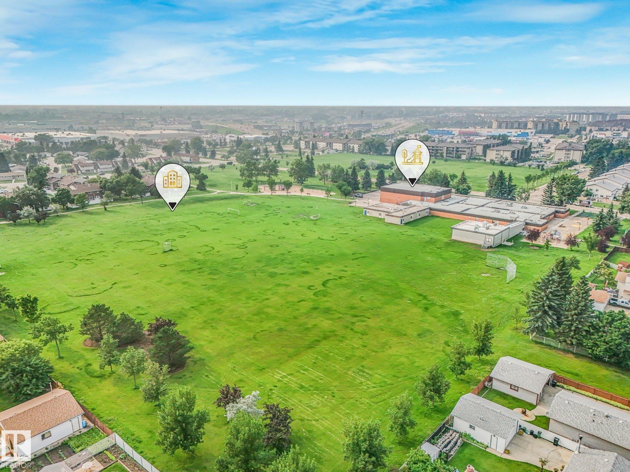 Expansive green space featuring a large field and mature trees - 4135 134 Avenue Nw, Edmonton, AB - Outdoor With View