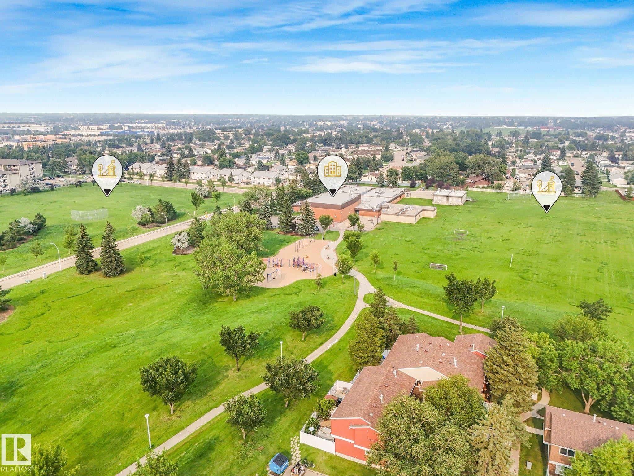 Expansive parkland setting featuring a playground, walking paths, and sports fields - 4135 134 Avenue Nw, Edmonton, AB - Outdoor With View