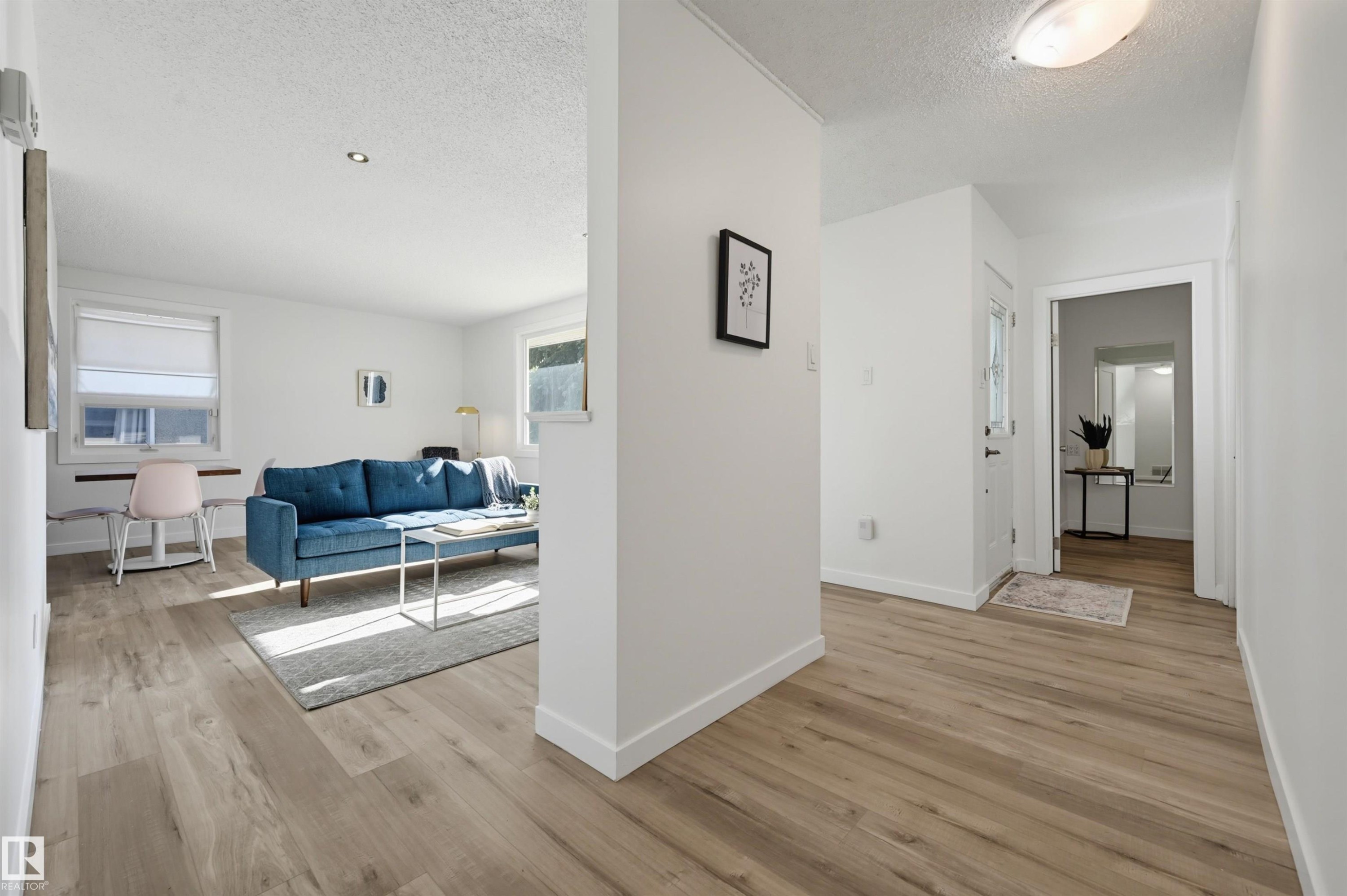 Wood-finish flooring throughout - 9127 149 Street Nw, Edmonton, AB - Indoor Photo Showing Other Room