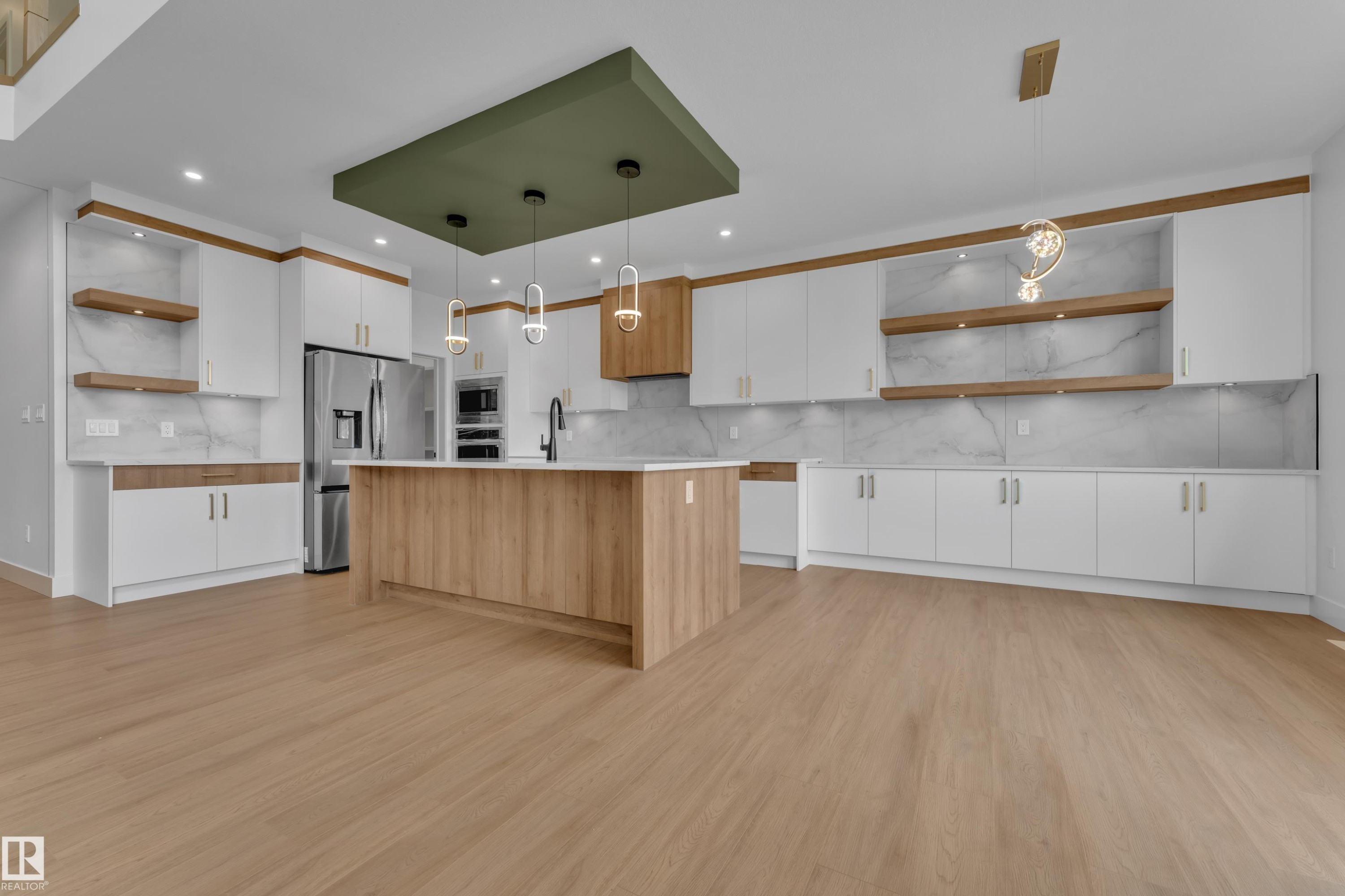 Light wood-finish flooring, white cabinetry with gold-toned hardware, center island with light countertop, built-in stainless steel appliances, and decorative suspended light fixtures - 764 Astoria Way, Devon, AB - Indoor Photo Showing Kitchen With Upgraded Kitchen