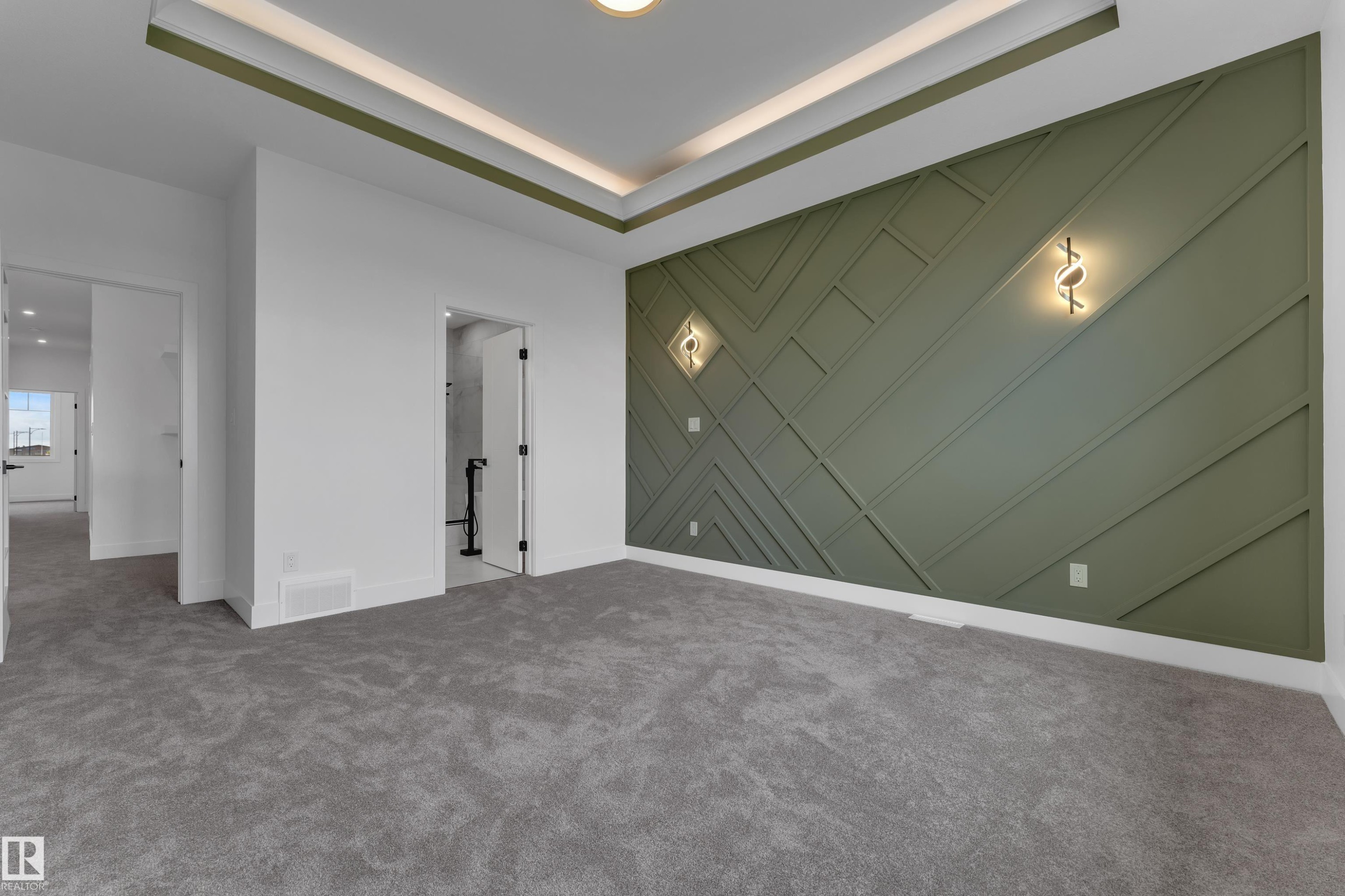 Recessed ceiling lighting, tray ceiling detail, feature wall with geometric paneling, decorative wall sconces, and neutral-toned carpeting - 764 Astoria Way, Devon, AB - Indoor Photo Showing Other Room