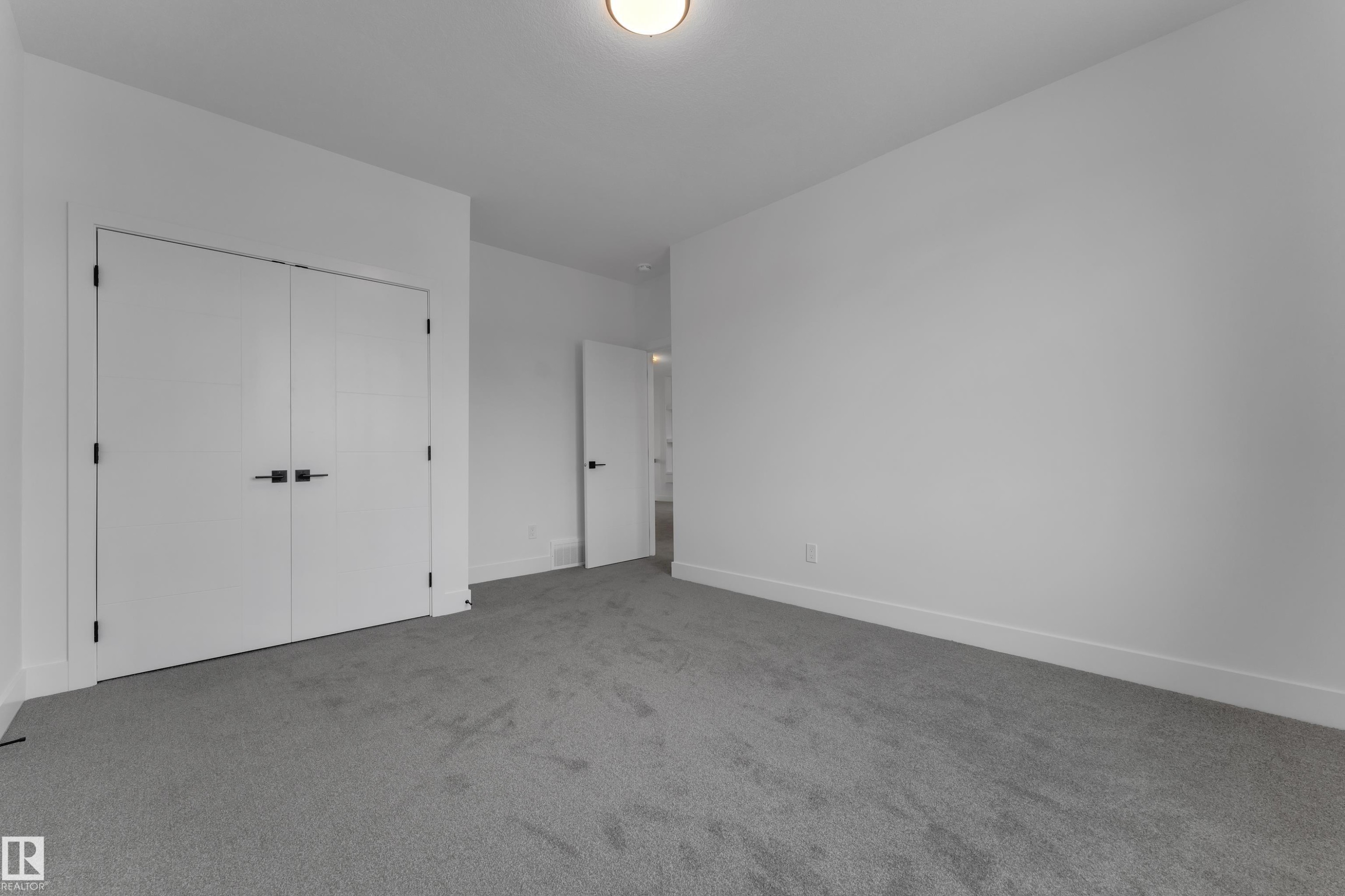 Neutral wall paint, plush carpeting, white trim, and a ceiling light fixture - 764 Astoria Way, Devon, AB - Indoor Photo Showing Other Room