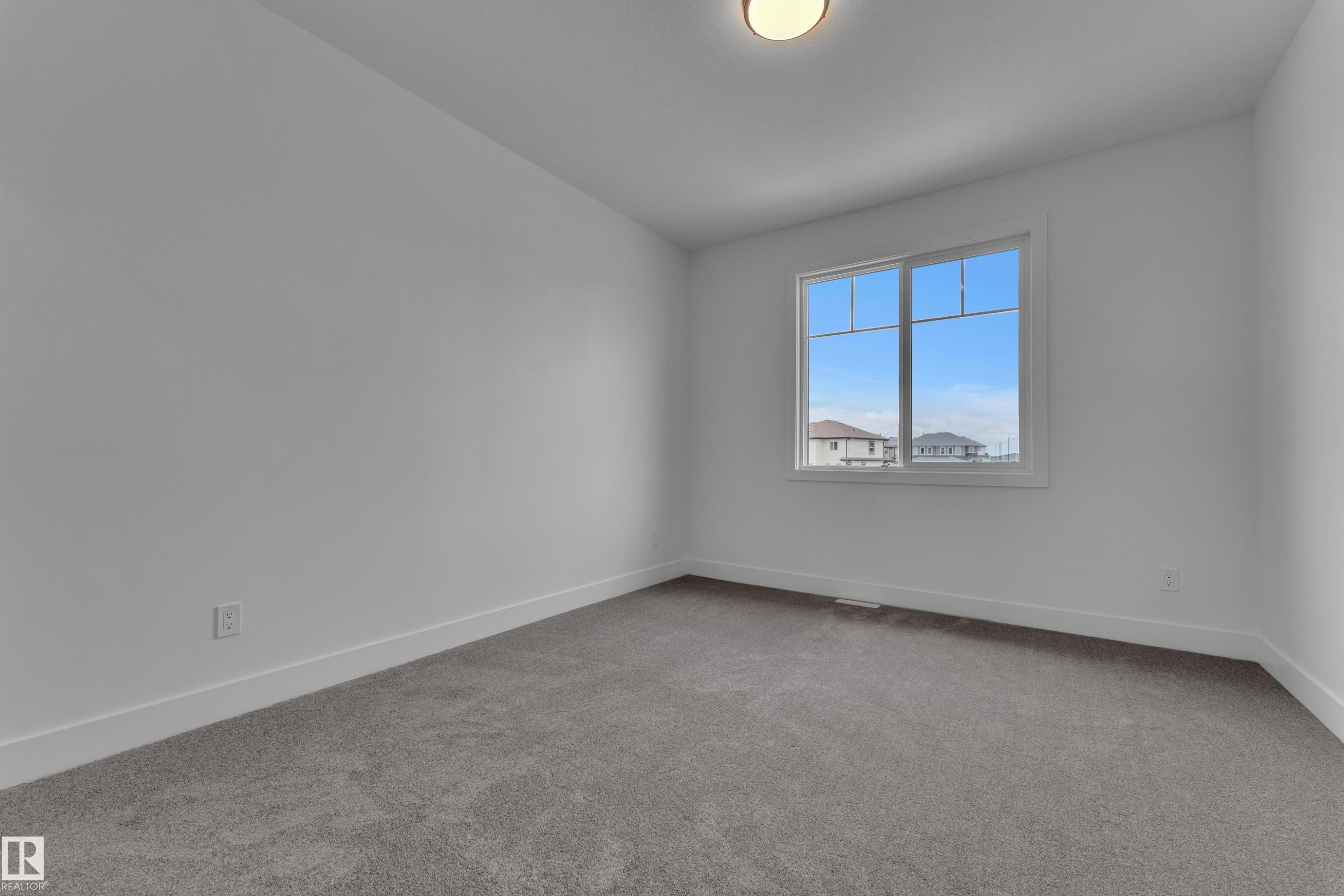 Neutral wall paint, gray carpet flooring, white trim, and a window with white framing - 764 Astoria Way, Devon, AB - Indoor Photo Showing Other Room
