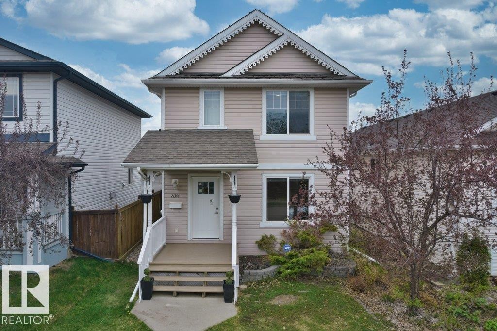 Two-story residence featuring light-colored siding and white trim - 21344 88 Avenue Nw, Edmonton, AB - Outdoor