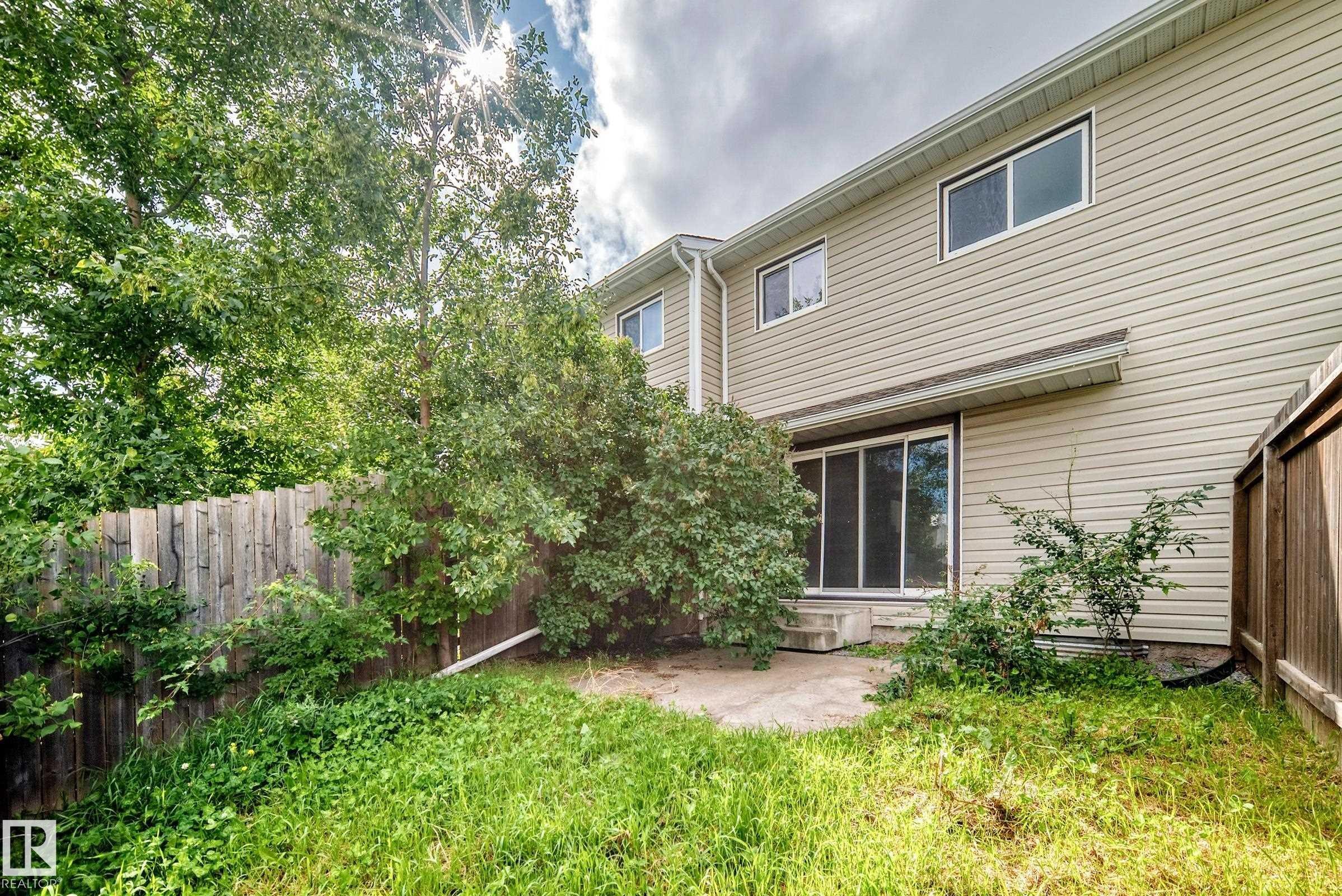 Rear exterior with light-toned siding and multiple windows - 6416 180 Street Nw, Edmonton, AB - Outdoor