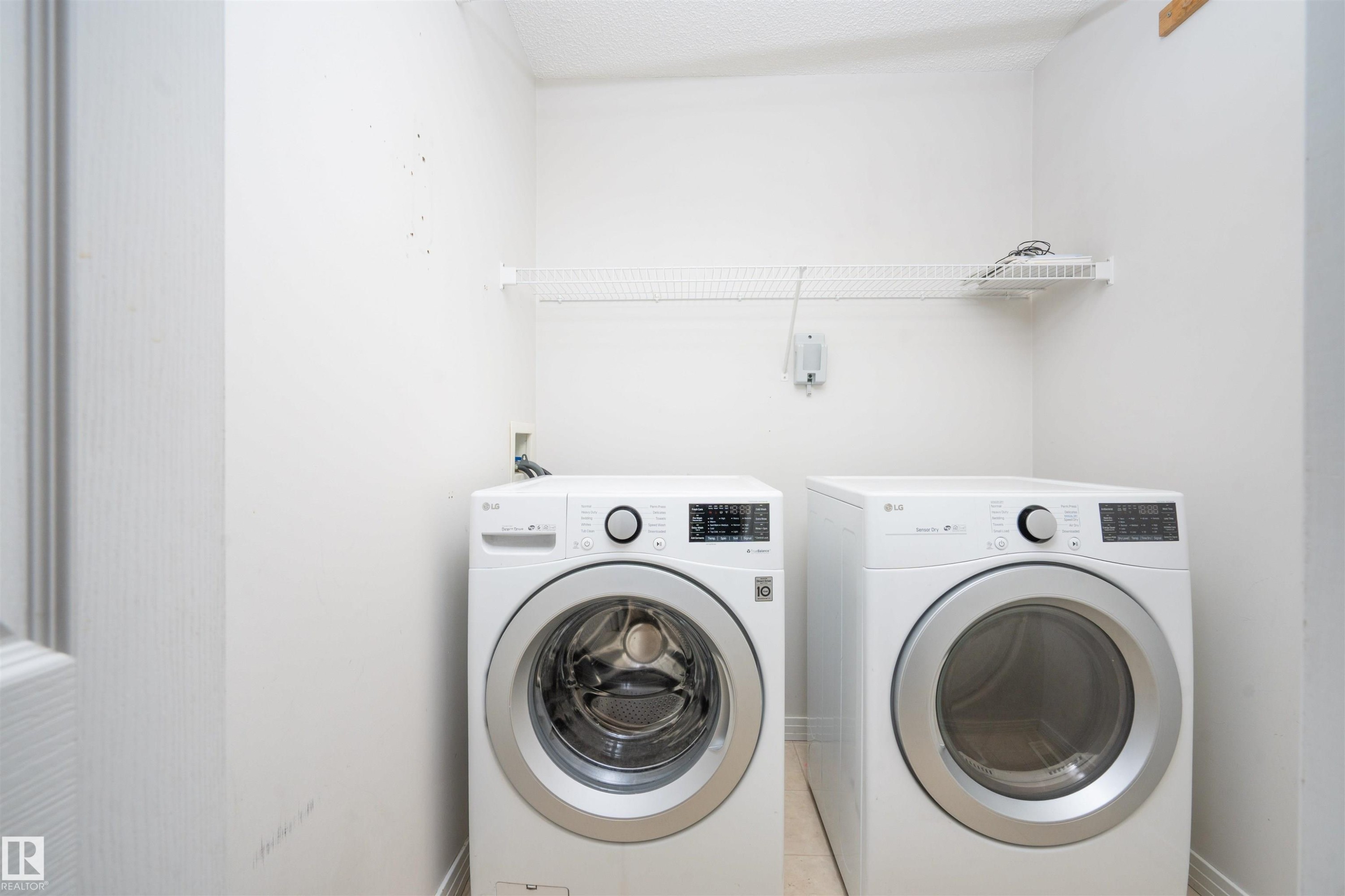 Dedicated laundry area with a wire storage shelf - 1009 Macewan Close Sw, Edmonton, AB - Indoor Photo Showing Laundry Room