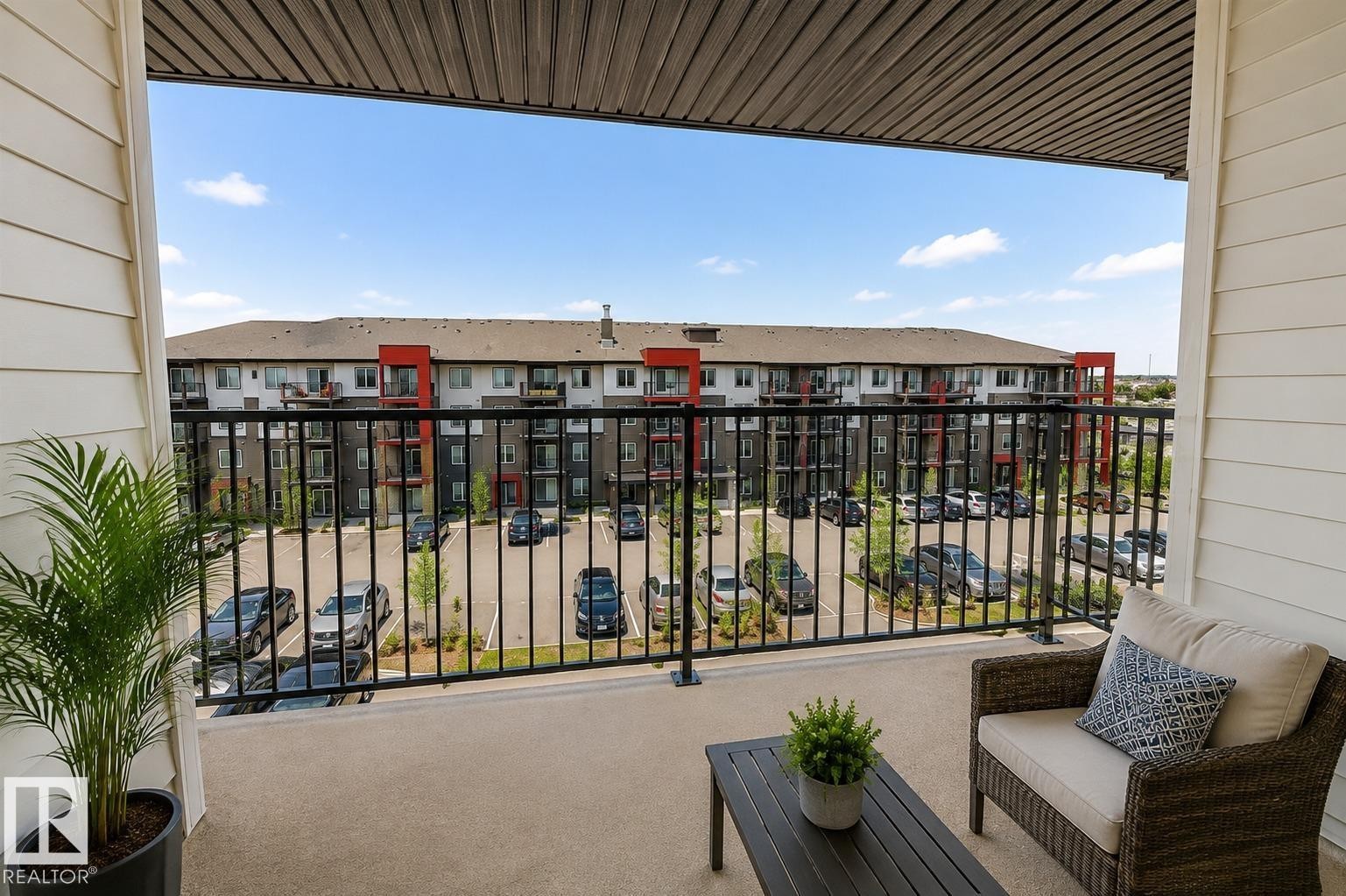 Private balcony with concrete flooring, black metal railing, and horizontal siding - #430 5515 7 Av Sw, Edmonton, AB - Outdoor With Balcony With Exterior
