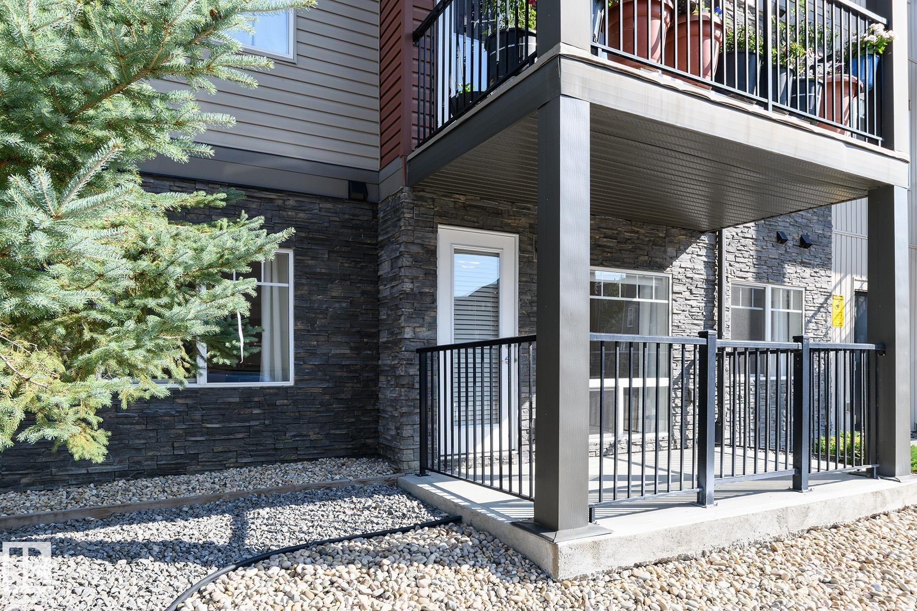 Stone veneer facade with horizontal siding accents - #110 9523 160 Av Nw, Edmonton, AB