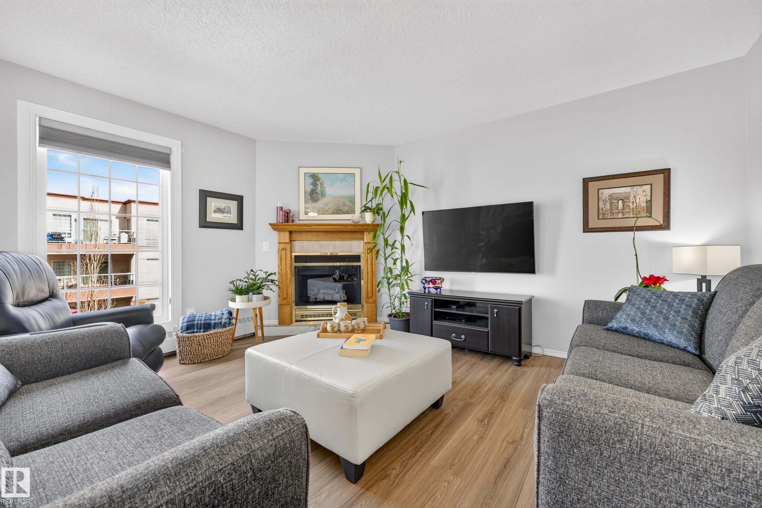 #405 3 Perron St, St. Albert, AB - Indoor Photo Showing Living Room With Fireplace