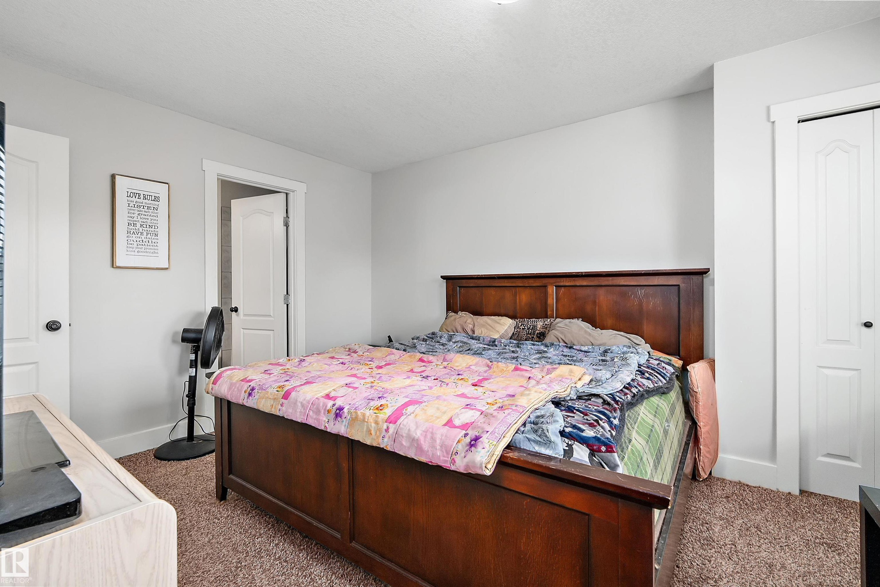 Neutral wall paint, textured carpeting, and white trim - 203 Graybriar Green, Stony Plain, AB - Indoor Photo Showing Bedroom