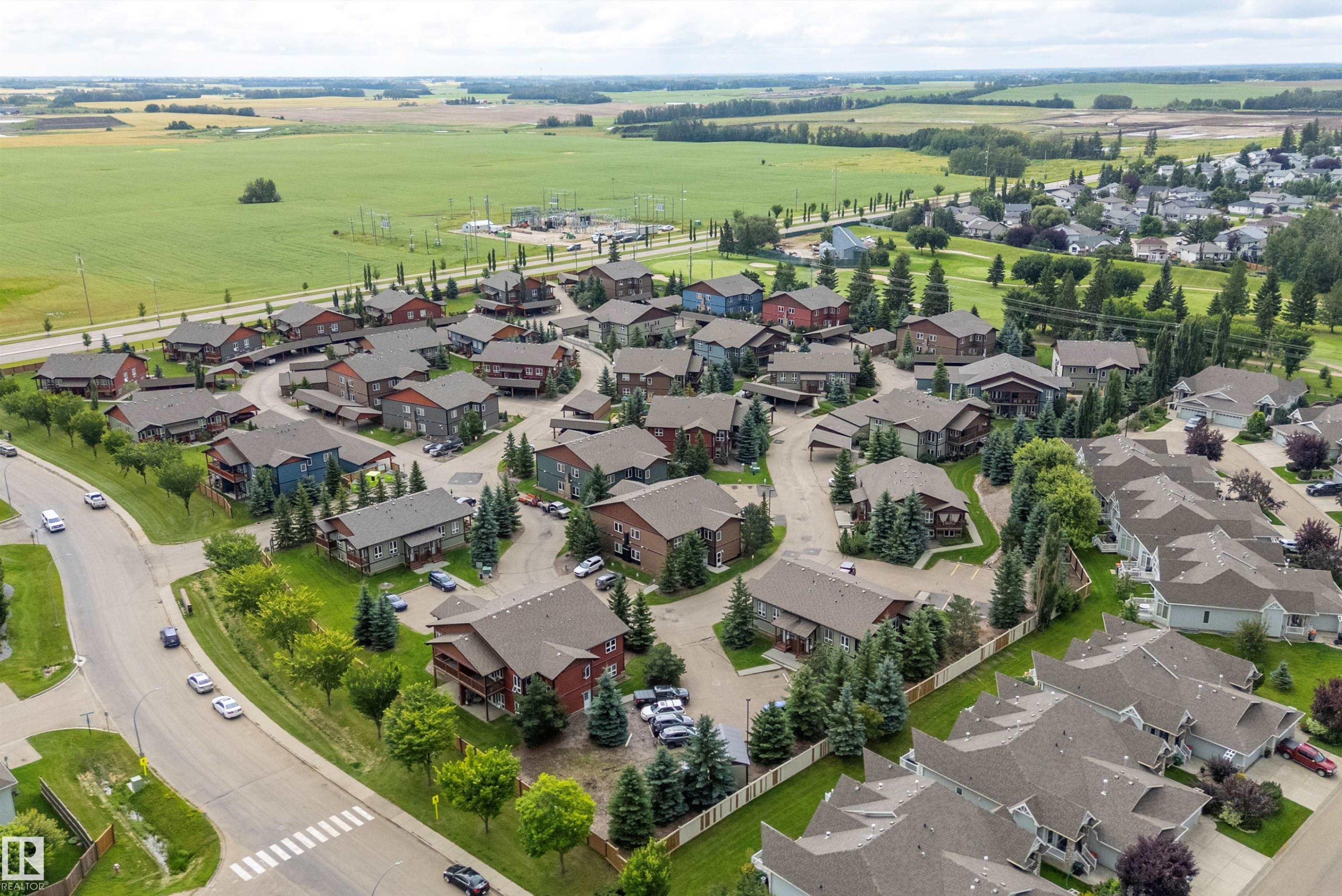 Residential community featuring detached and attached properties with varied rooflines - 203 Graybriar Green, Stony Plain, AB - Outdoor With View