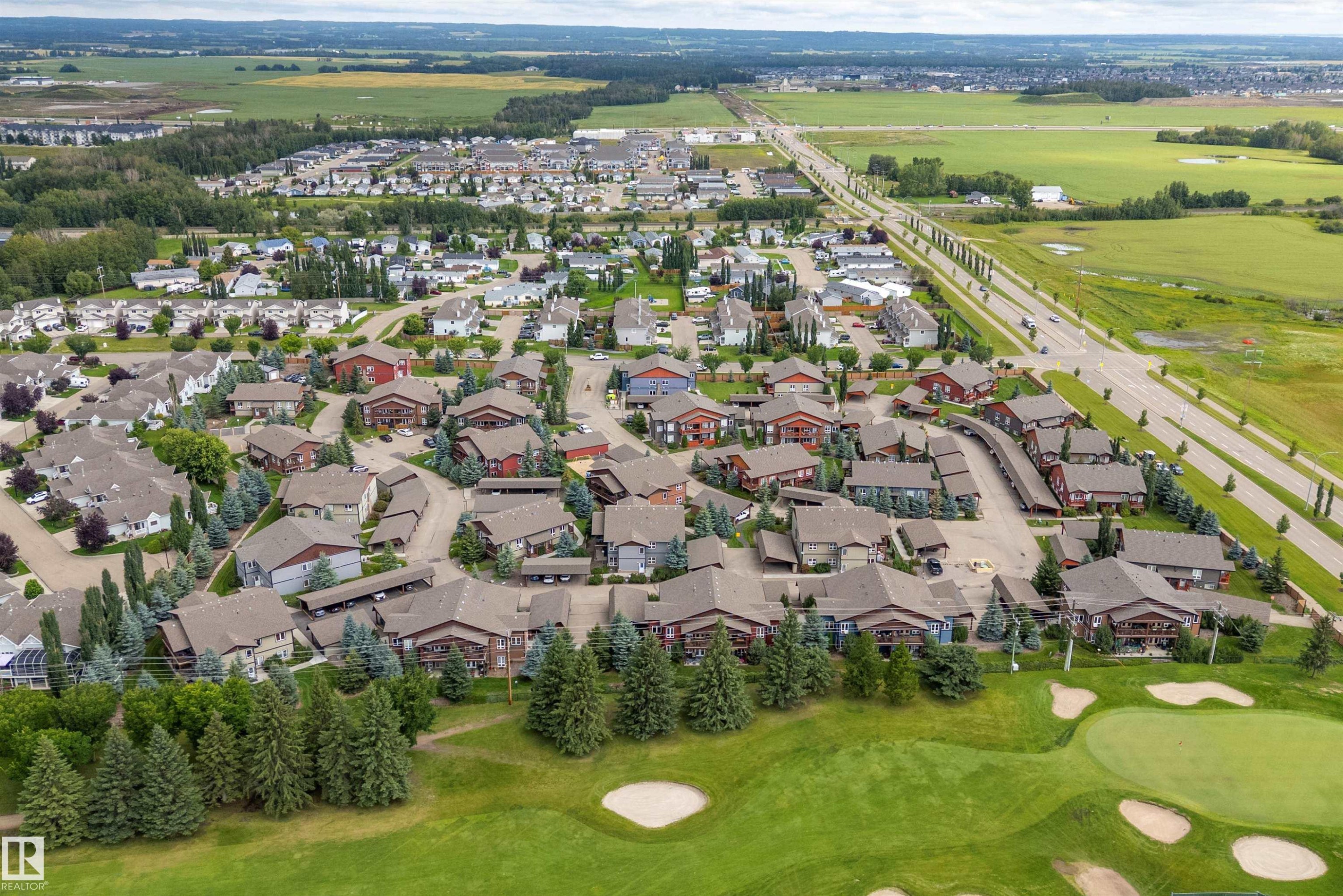 Residential community featuring a golf course, mature trees, and paved roadways - 203 Graybriar Green, Stony Plain, AB - Outdoor With View
