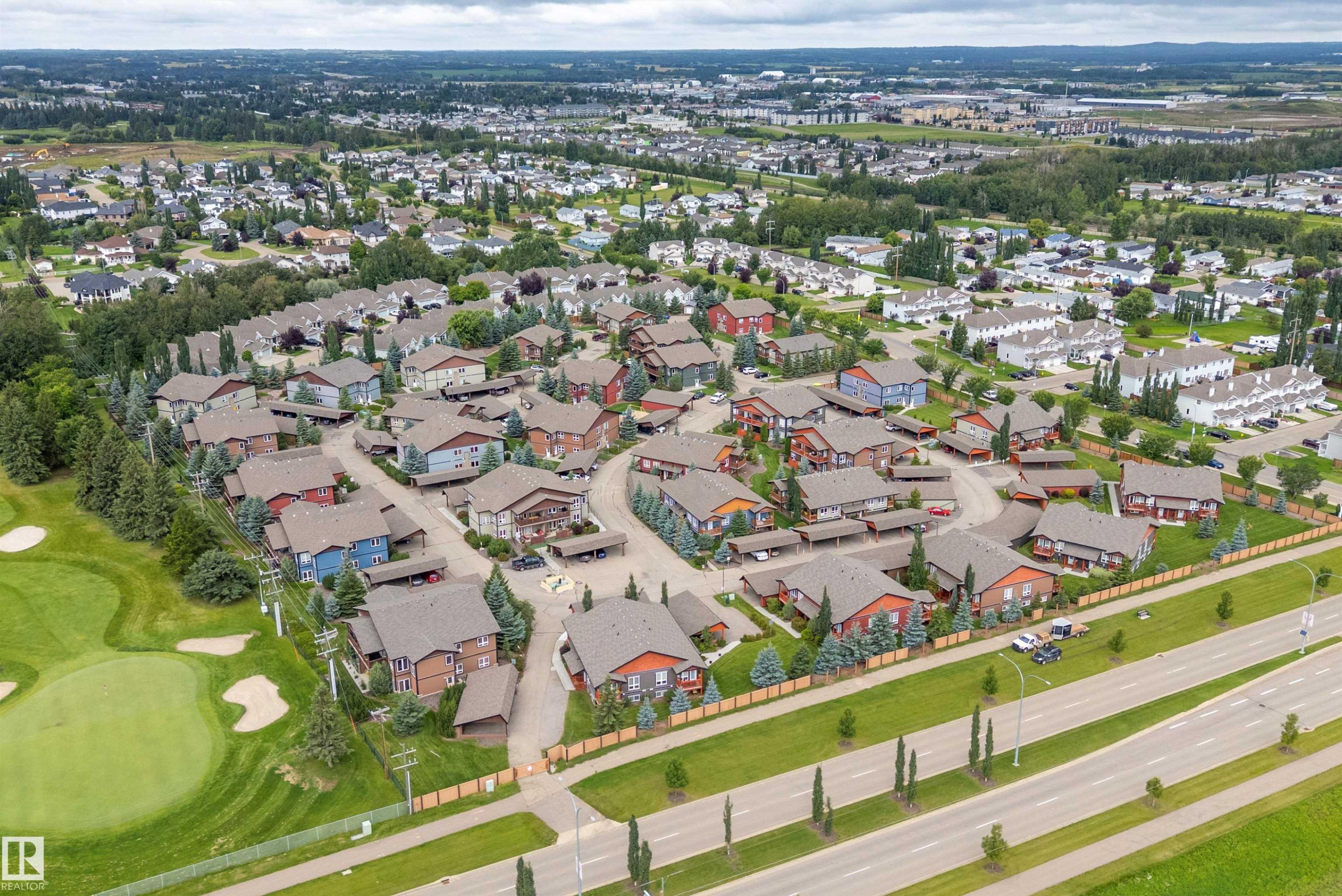 Residential neighborhood with a golf course border, mature trees, and varying architectural styles - 203 Graybriar Green, Stony Plain, AB - Outdoor With View