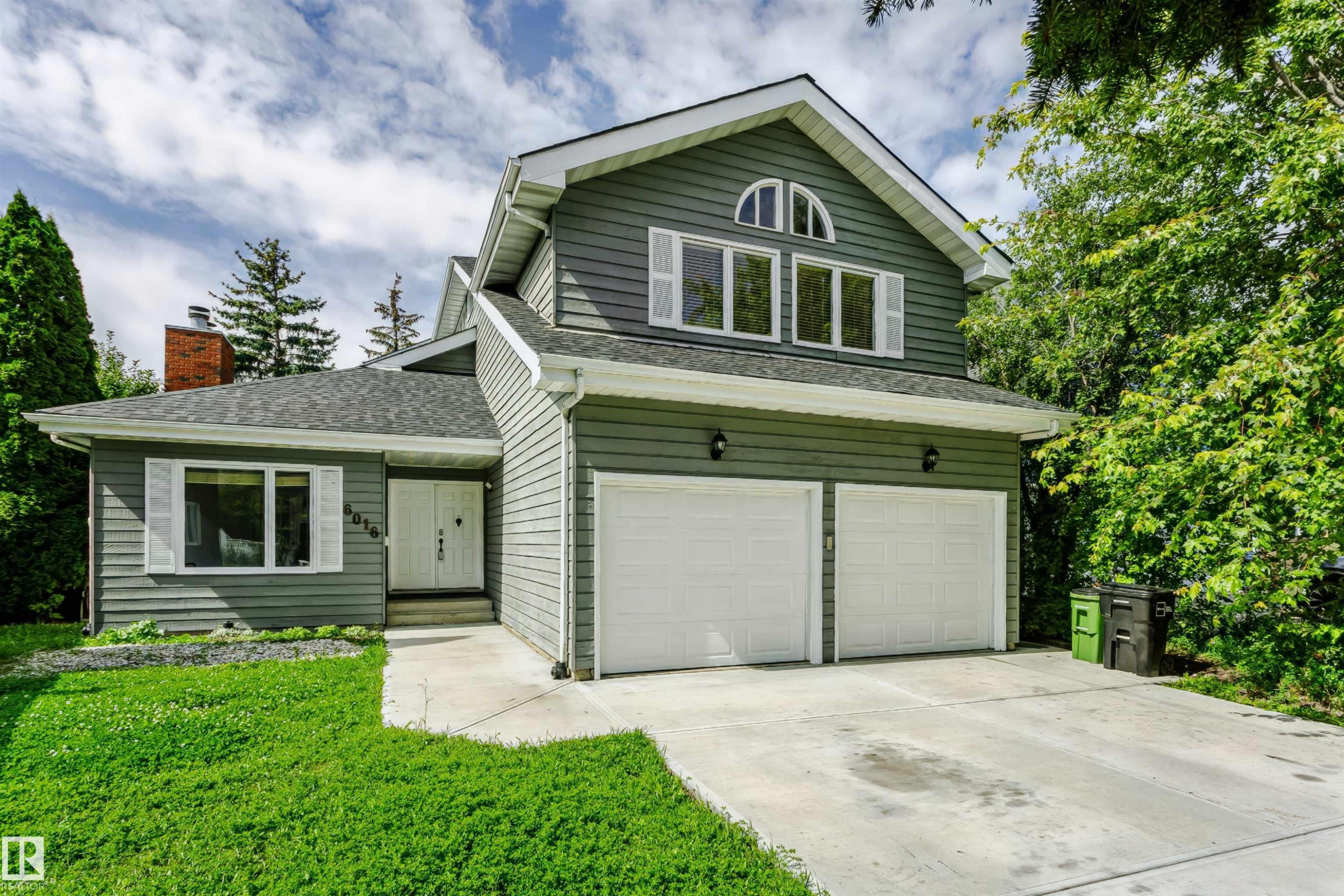 Gable roofline with dormer windows, two-car garage, and brick chimney detail - 6016 177 Street Nw, Edmonton, AB - Outdoor