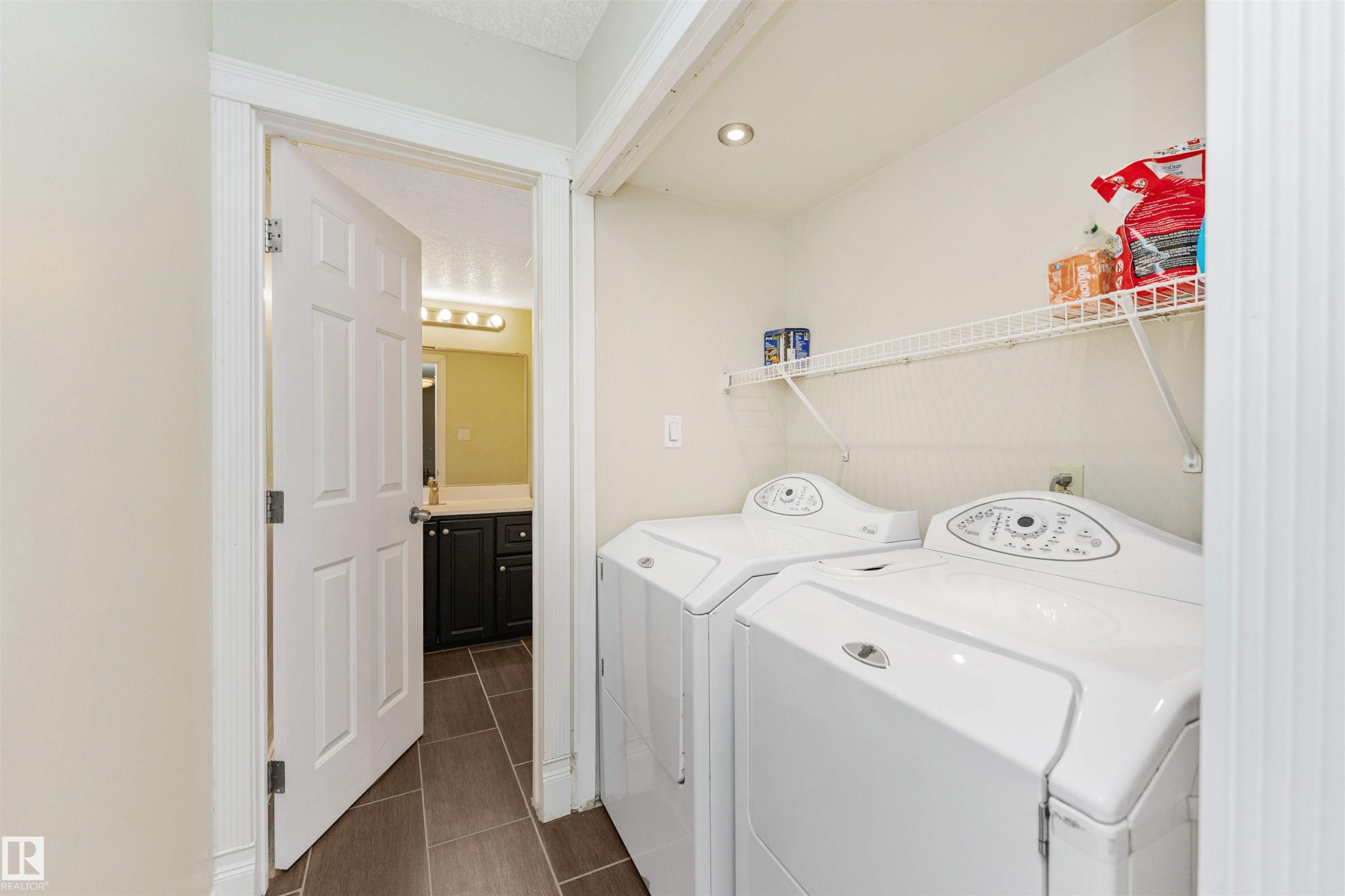 Integrated laundry area with tile flooring and wire shelving - 6016 177 Street Nw, Edmonton, AB - Indoor Photo Showing Laundry Room