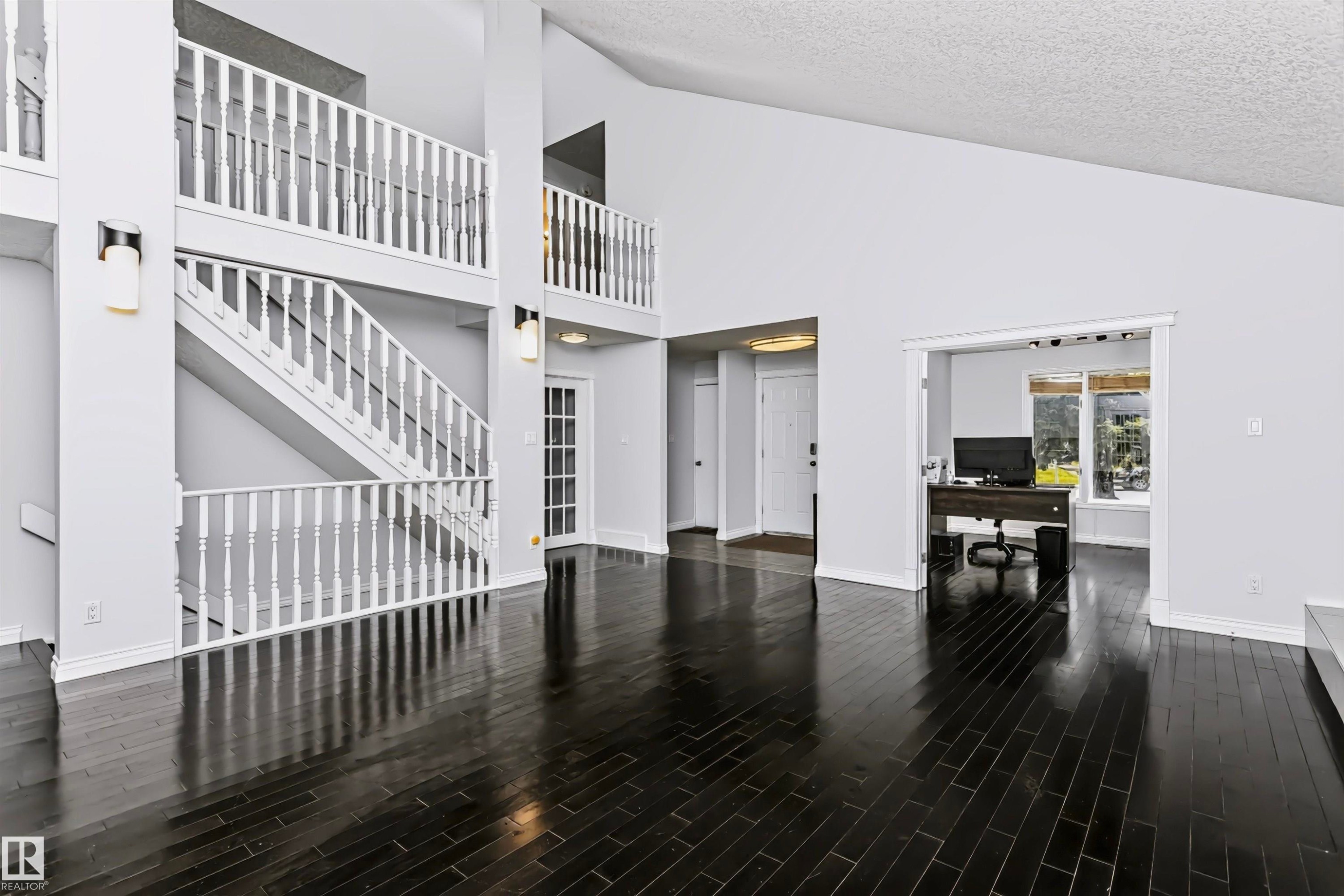 Vaulted ceilings with dark wood-finish flooring - 6016 177 Street Nw, Edmonton, AB - Indoor Photo Showing Other Room