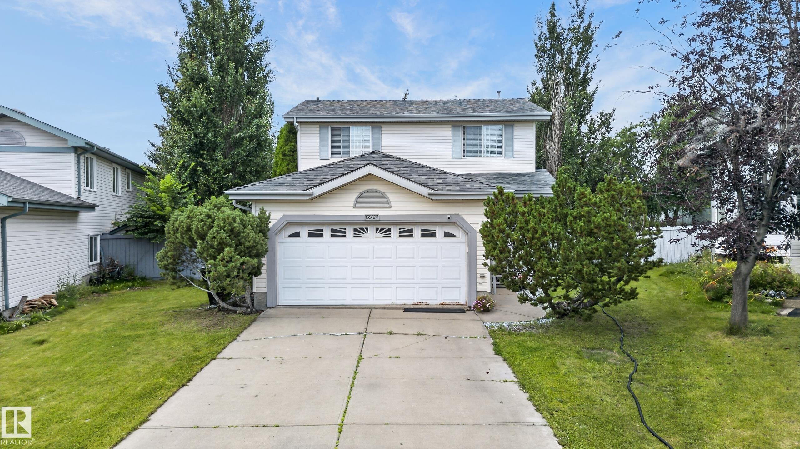 Two-story home featuring a white exterior with peaked roofline and architectural detailing - 12724 148 Avenue Nw, Edmonton, AB - Outdoor