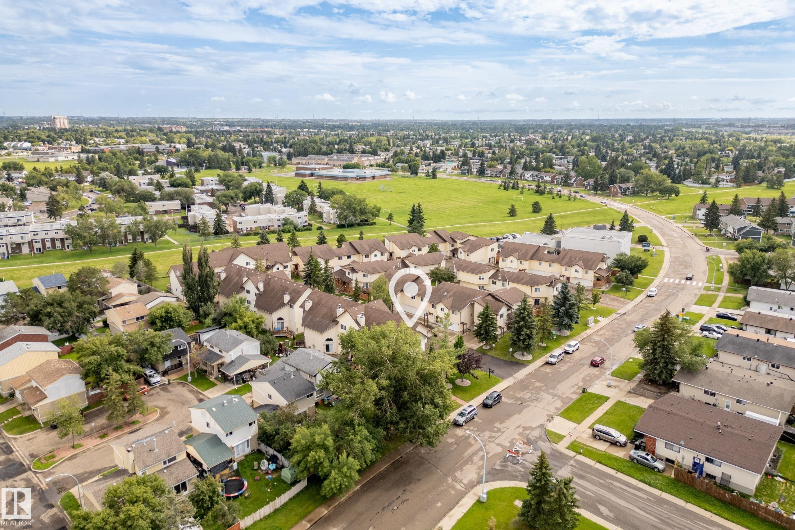 Residential neighborhood with mature trees, paved streets, and a large green space - #25 3811 85 St Nw, Edmonton, AB - Outdoor With View
