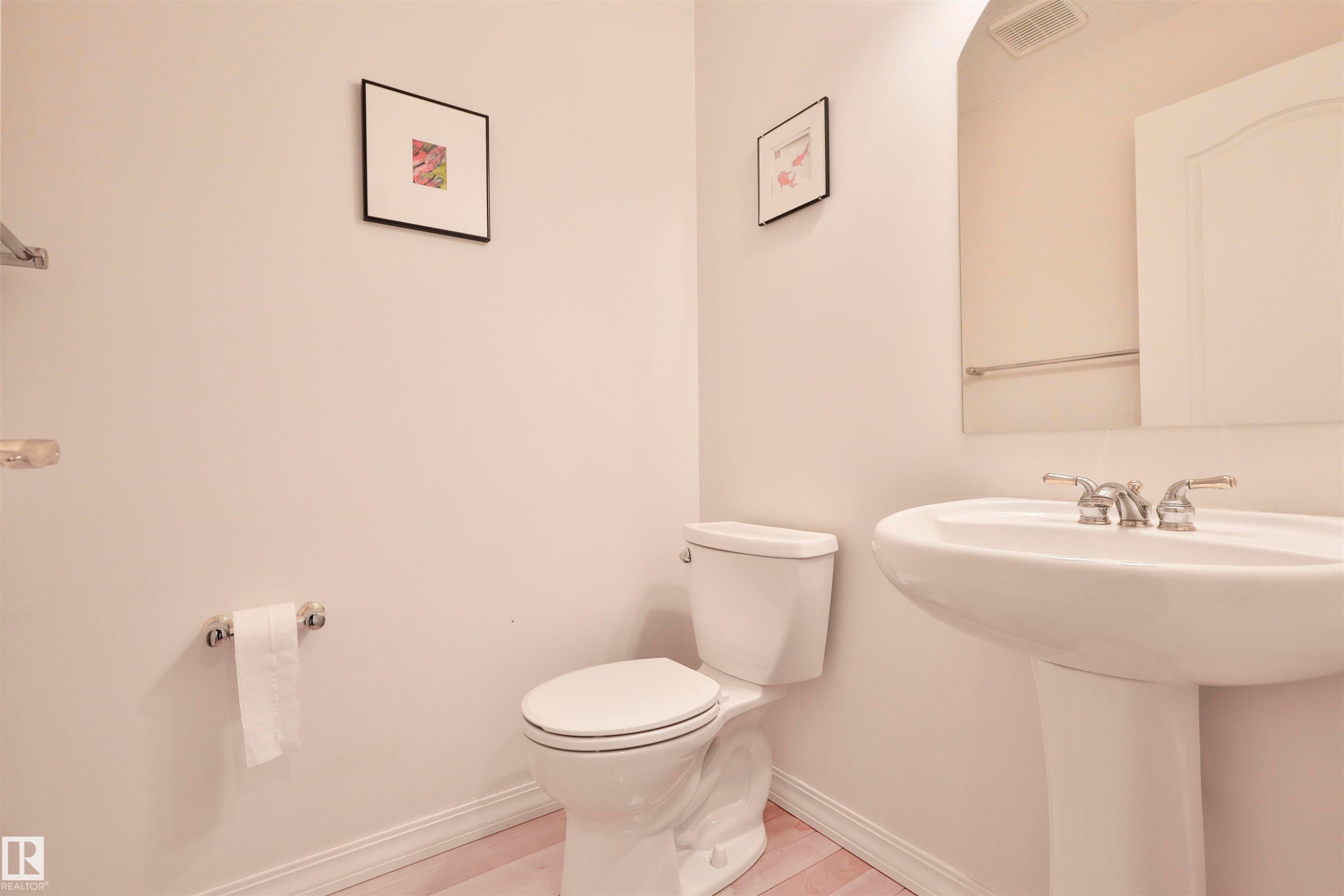 Pedestal sink with chrome hardware and a wall-mounted mirror - 237 Darlington Crescent Nw, Edmonton, AB - Indoor Photo Showing Bathroom
