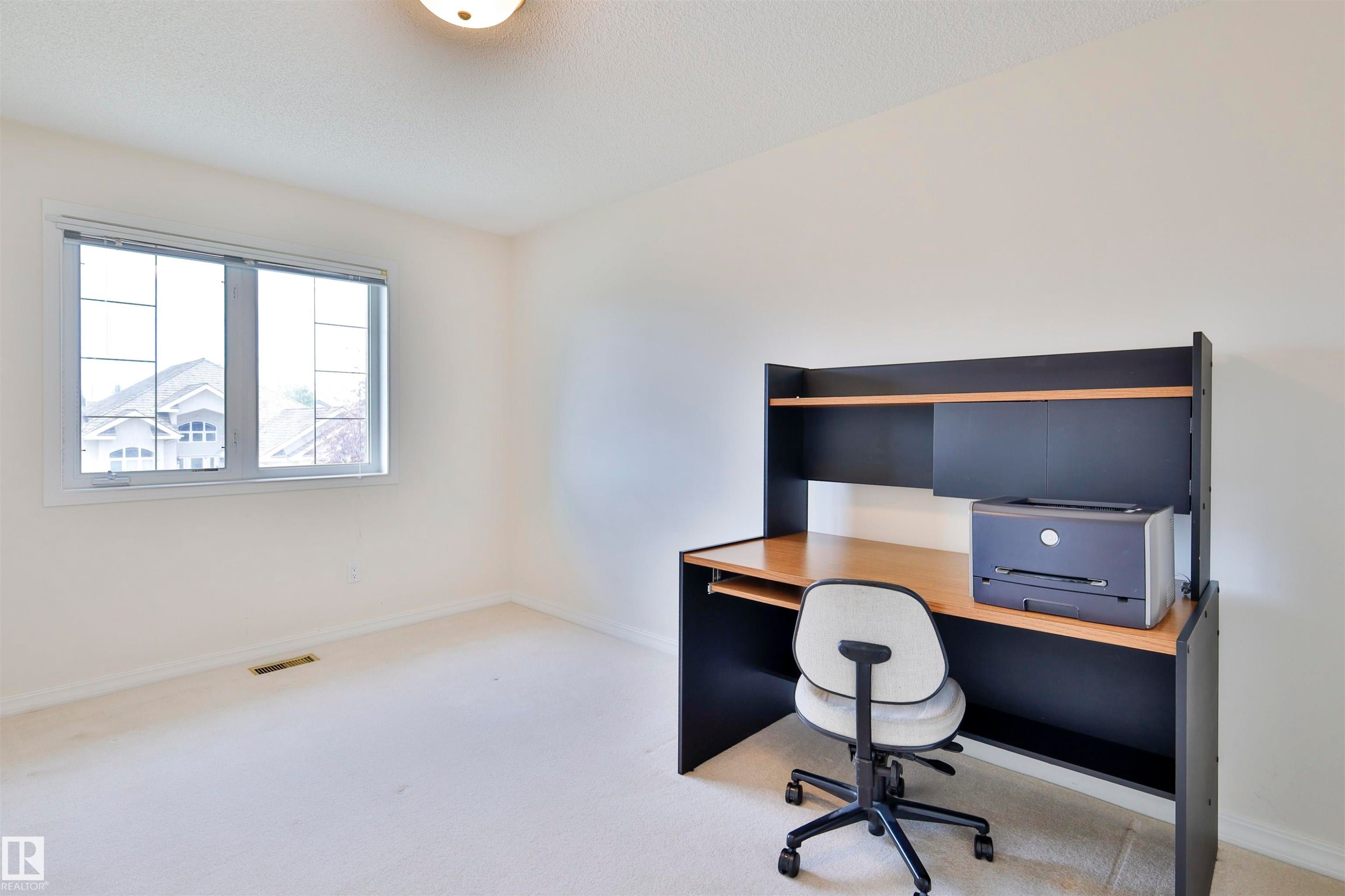 Window with white trim and muntins, ceiling-mounted light fixture, and light-toned carpeting - 237 Darlington Crescent Nw, Edmonton, AB - Indoor Photo Showing Other Room