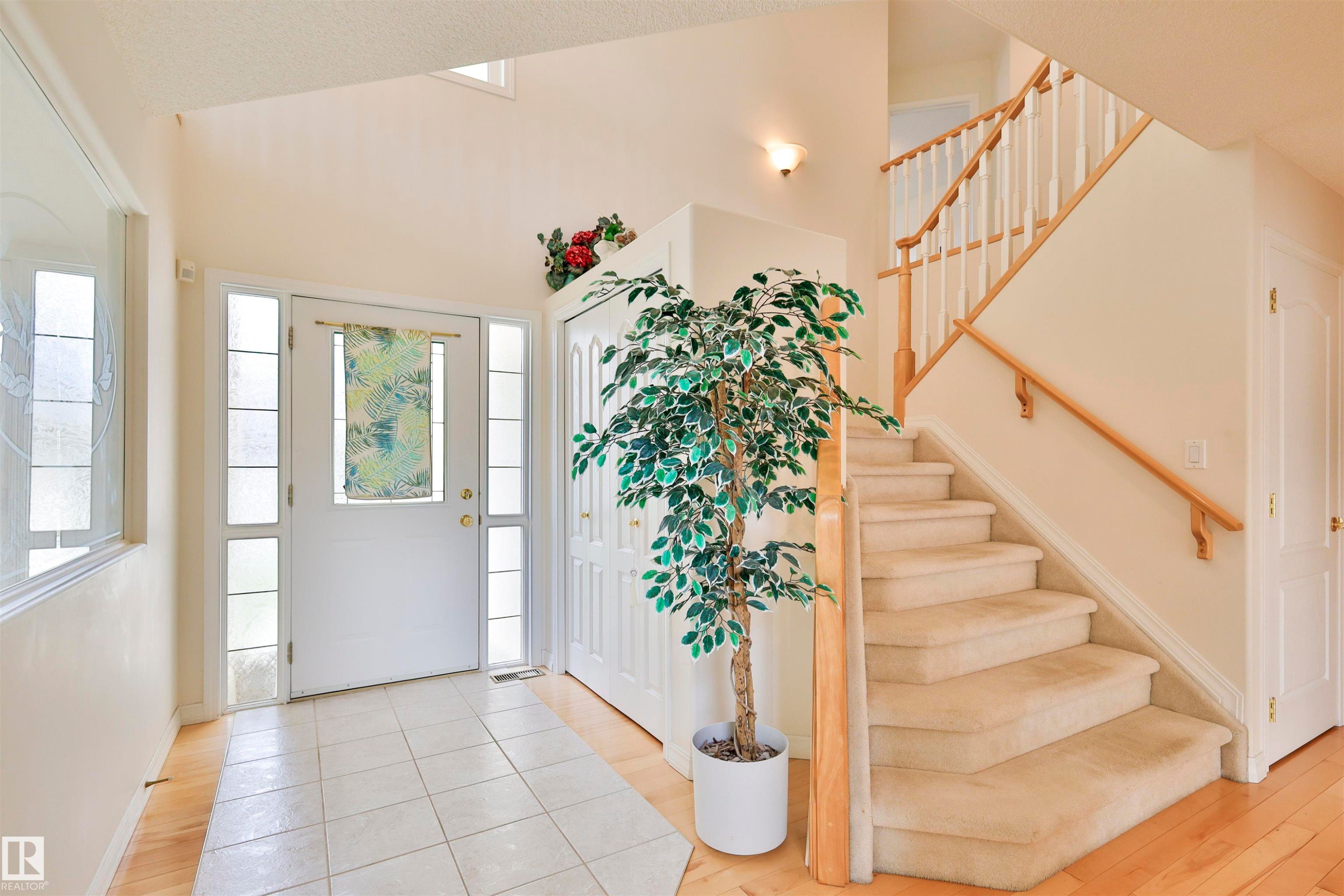 Entryway featuring a white paneled door with sidelights, transom window, and tile flooring - 237 Darlington Crescent Nw, Edmonton, AB - Indoor Photo Showing Other Room