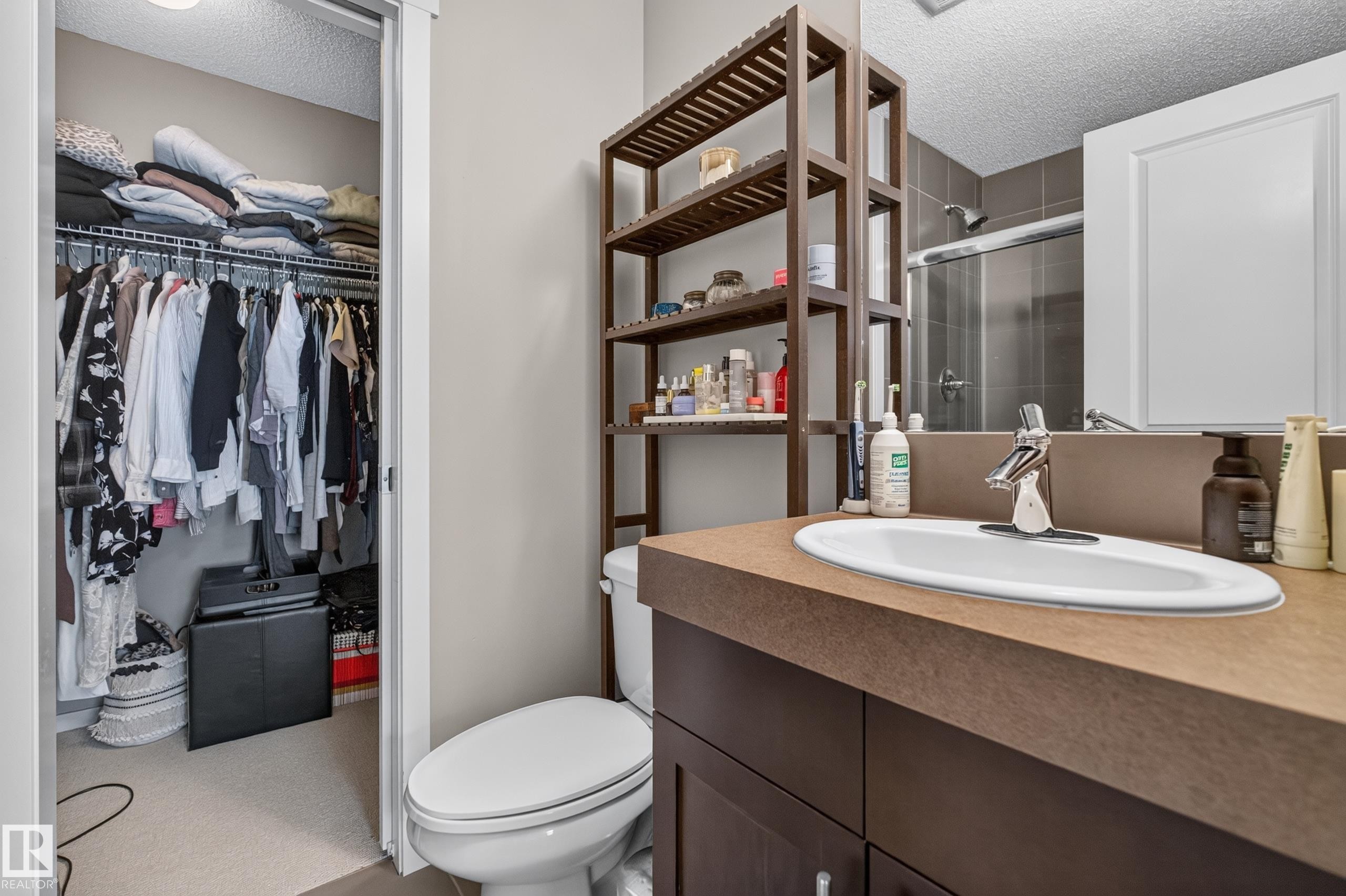 Bathroom vanity featuring a single basin, chrome faucet, and brown countertop - #53 603 Watt Bv Sw, Edmonton, AB - Indoor Photo Showing Bathroom