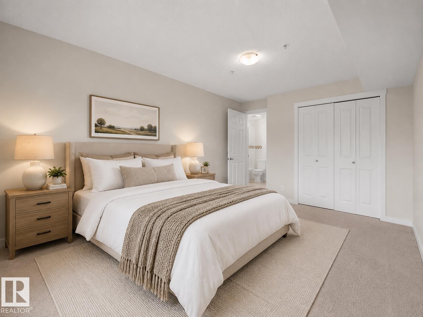 Bedroom featuring neutral-toned carpeting, a light-colored upholstered bed frame, and a flush mount ceiling light - #220 5804 Mullen Pl Nw, Edmonton, AB
