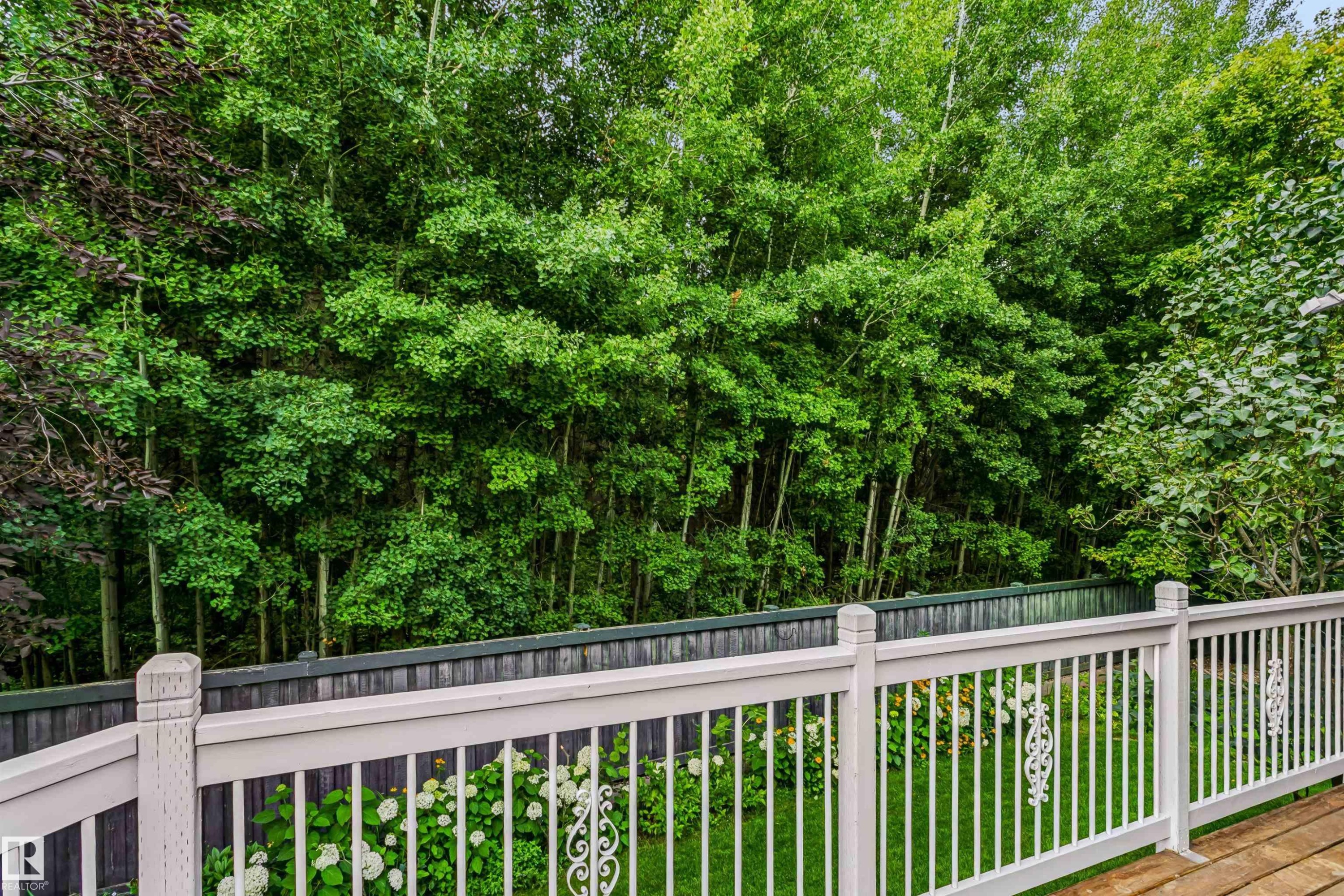 Wood-finish deck with white railing, featuring decorative metal inserts - 1720 Robertson Place Sw, Edmonton, AB - Outdoor