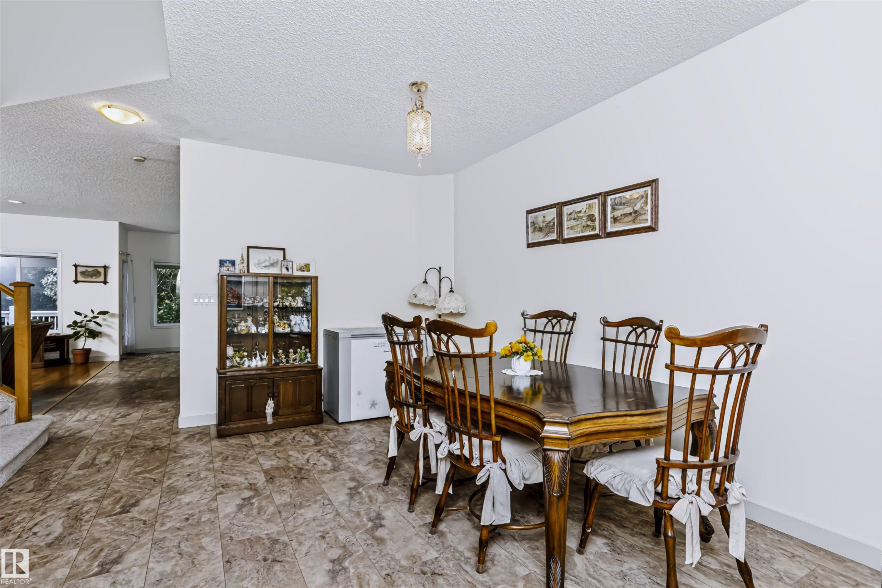 Tile flooring extending through the space - 1720 Robertson Place Sw, Edmonton, AB - Indoor Photo Showing Dining Room