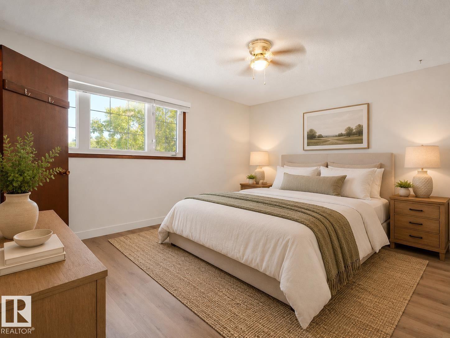 Wood-finish flooring, ceiling fan with integrated lighting, wood trim around window, wood door, and upholstered headboard - 7357 18 Avenue Nw, Edmonton, AB - Indoor Photo Showing Bedroom