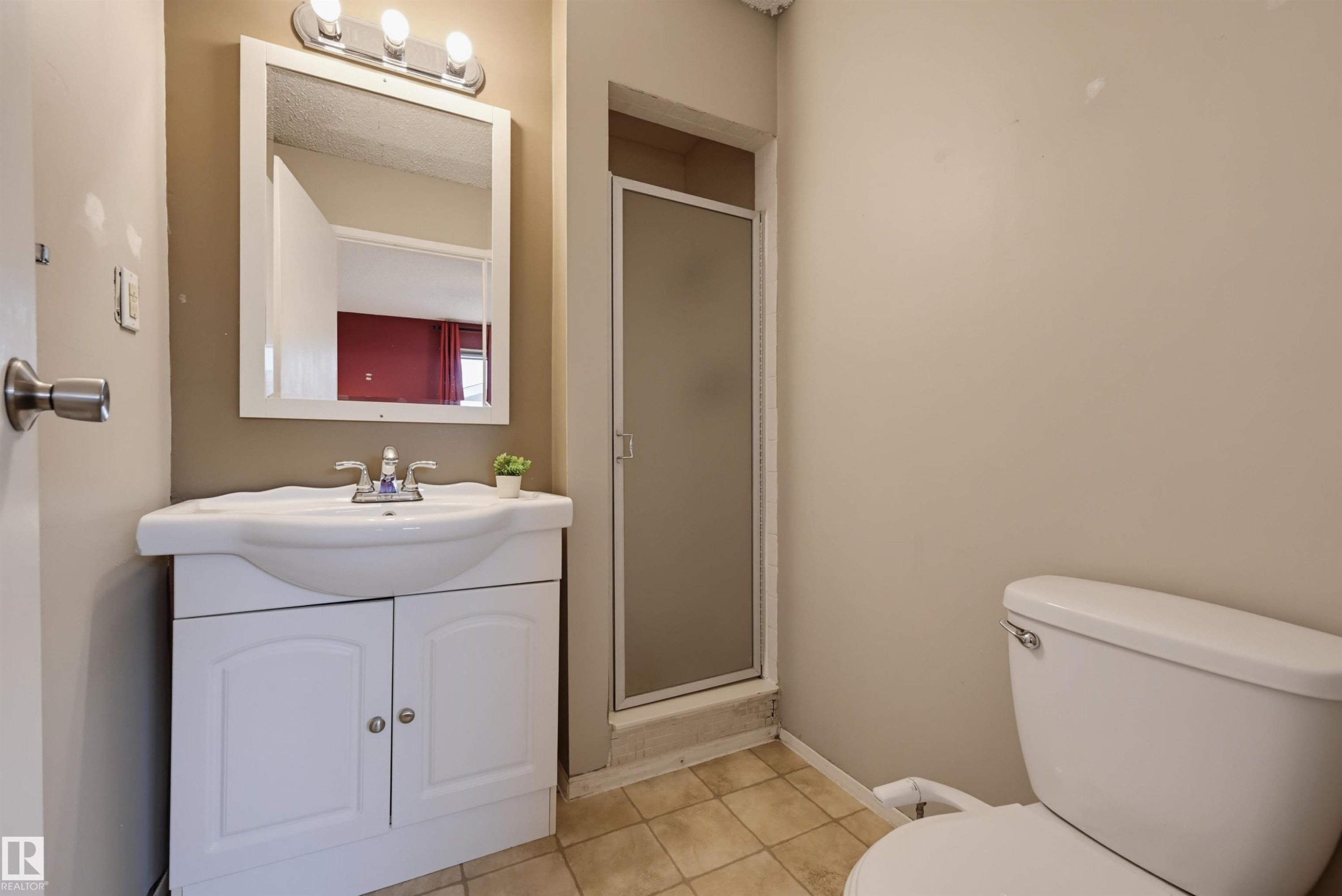 White vanity with integrated basin, chrome faucet, and overhead lighting - 6768 39 Avenue Nw, Edmonton, AB - Indoor Photo Showing Bathroom
