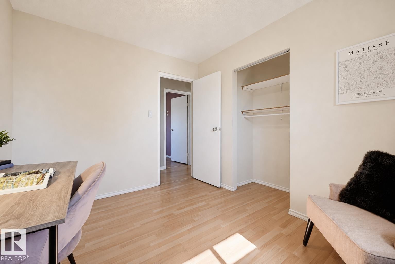 Light-toned wall finishes, wood-finish flooring, and a built-in closet with shelving and hanging rods - 6768 39 Avenue Nw, Edmonton, AB - Indoor